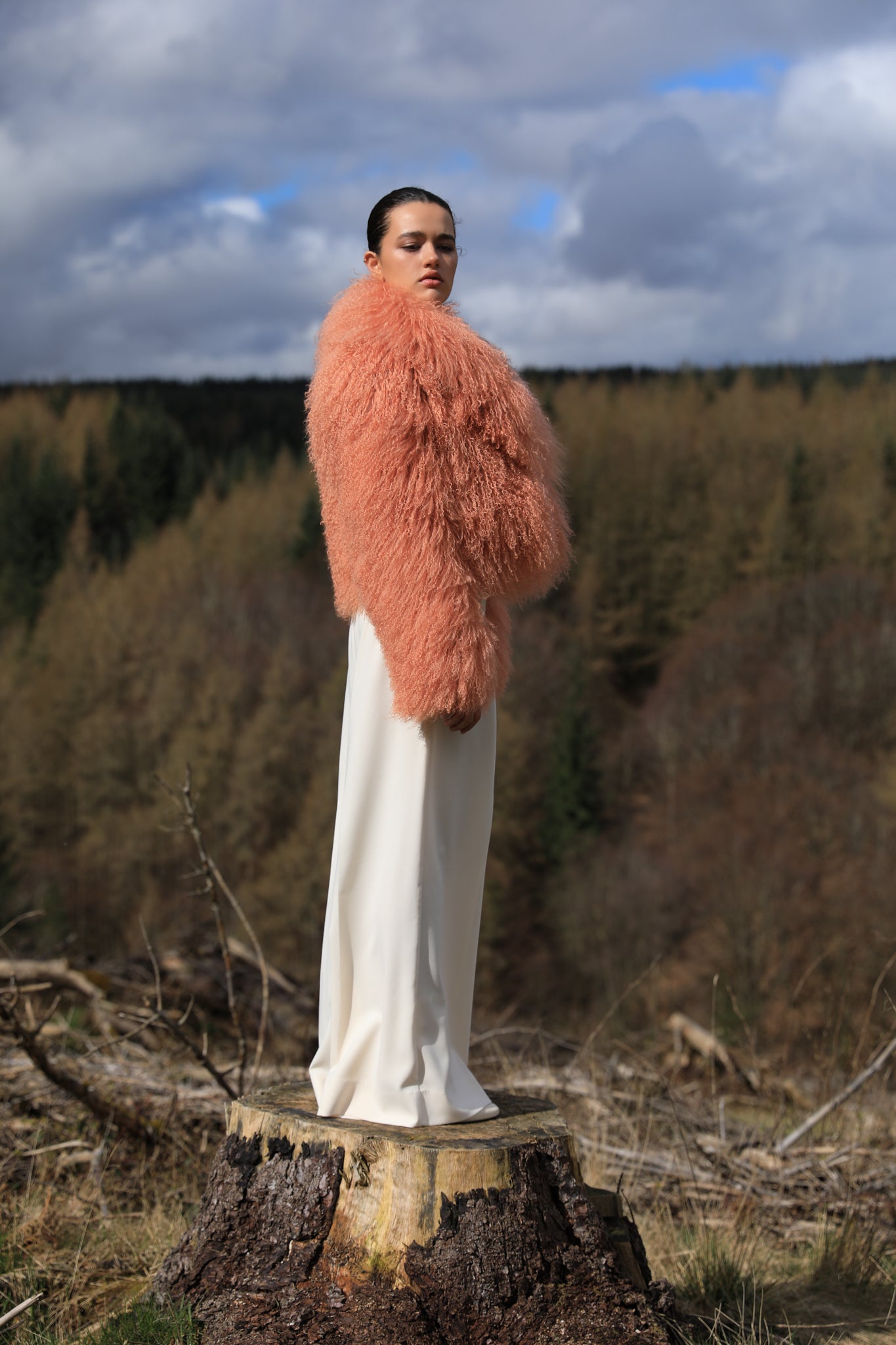 A timeless statement piece - Josephine Jones' voluminous collar Mongolian fur coat in peach hue, exuding elegance and luxury.