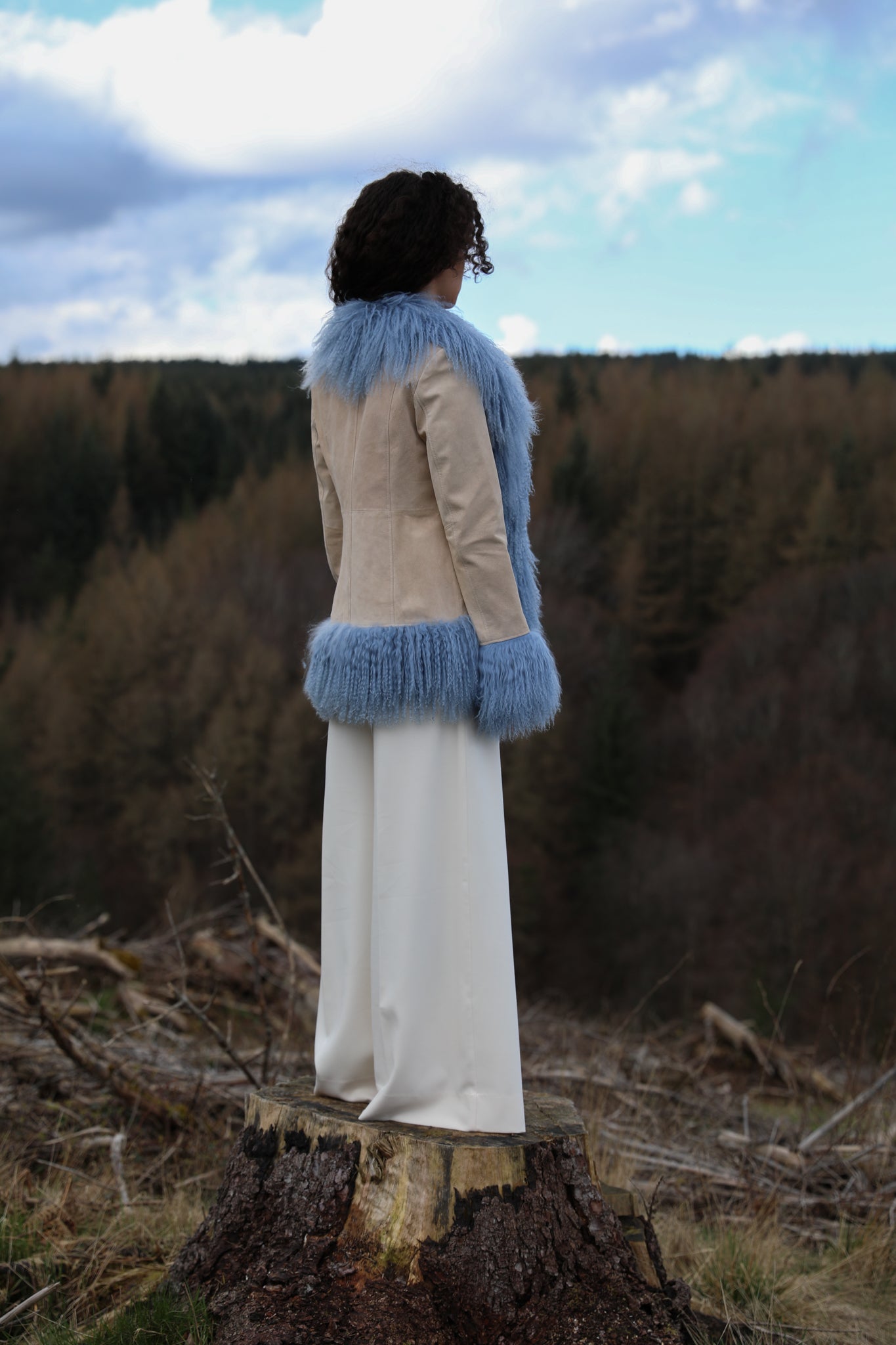 Josephine Jones' ivory suede Afghan penny lane style jacket adorned with cornflower blue Mongolian fur trims, offering a timeless and luxurious addition to any wardrobe.