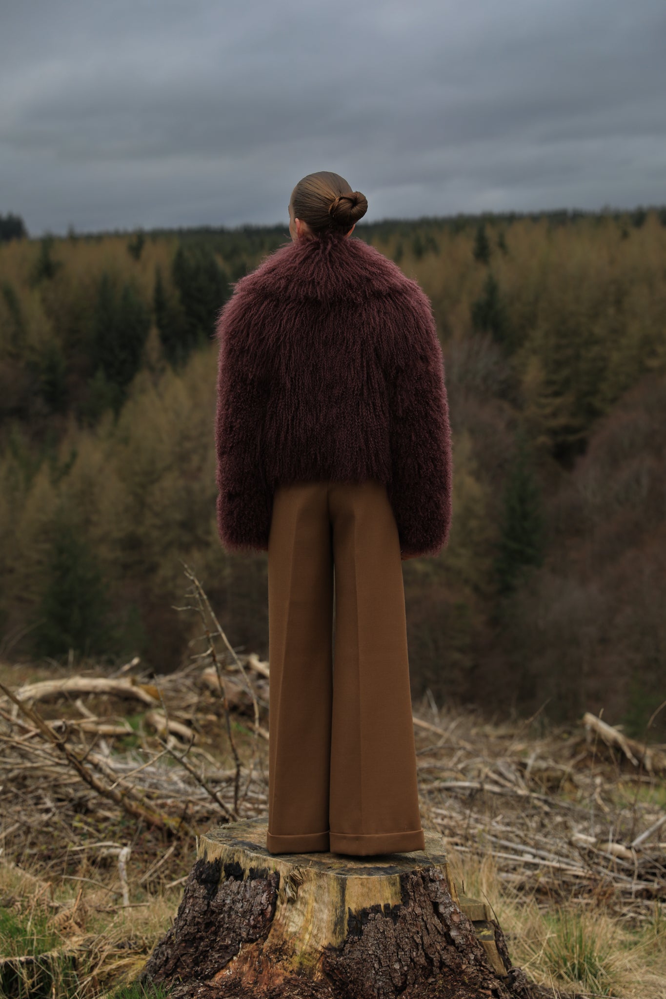  A burgundy voluminous collar Mongolian fur coat from Josephine Jones, a classic staple piece exuding elegance and luxury.