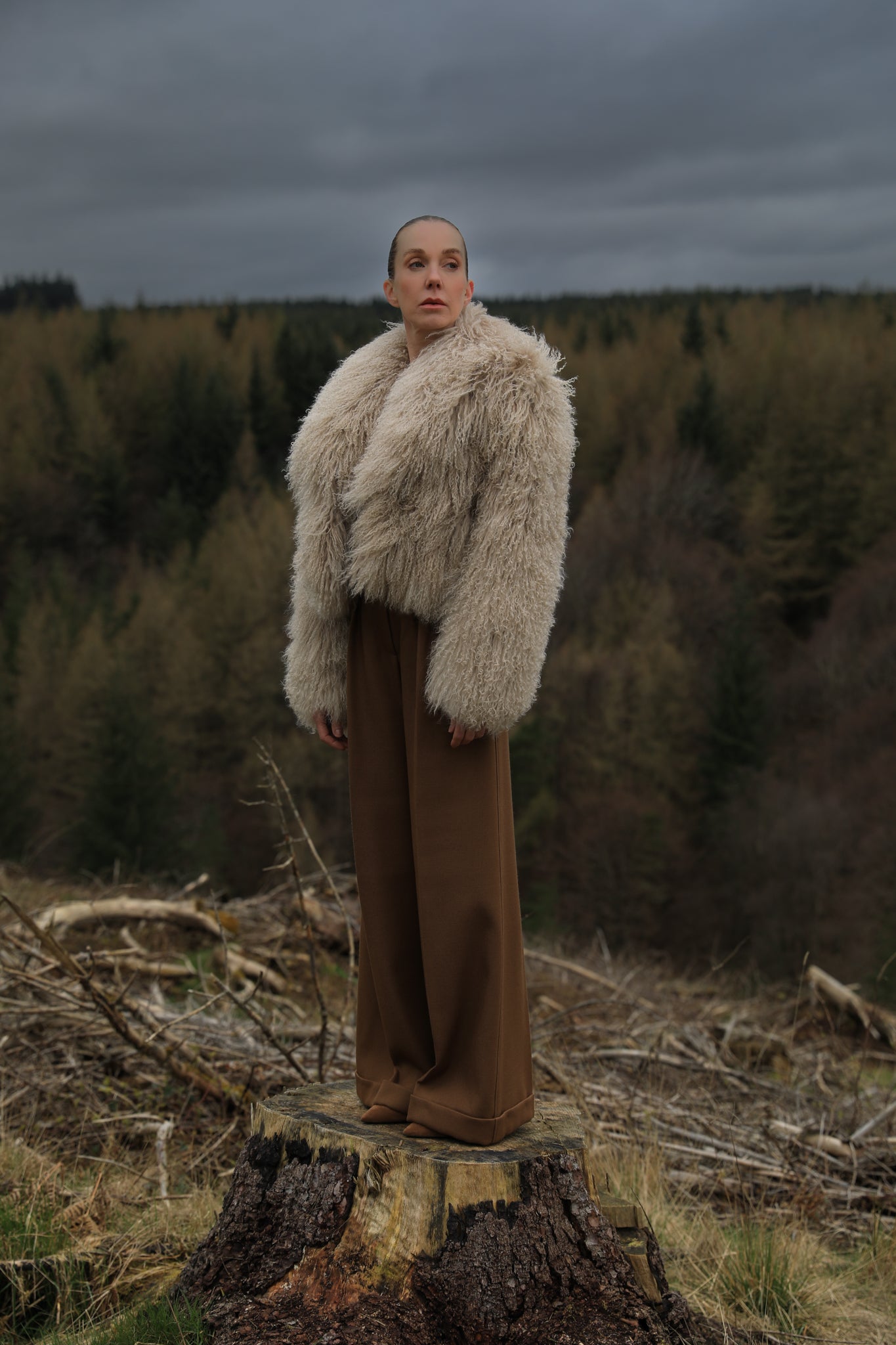 A  timeless beige Mongolian fur coat with a voluminous collar, a classic staple piece from Josephine Jones, exuding elegance and sophistication.