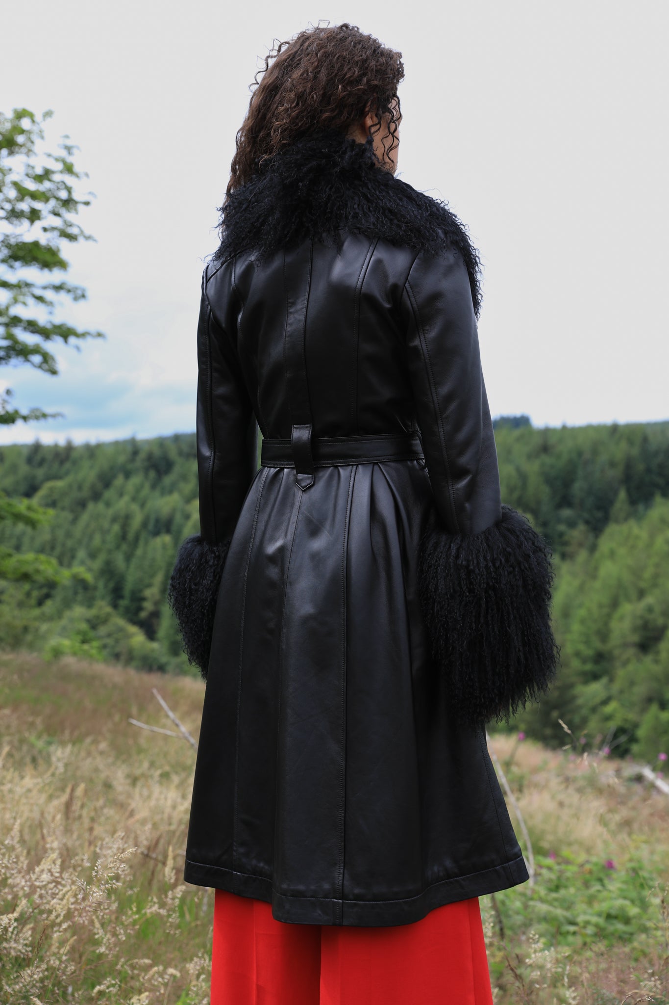 Josephine Jones genuine leather black trench coat featuring a luxurious Mongolian fur collar and cuffs. A timeless statement piece for sophisticated style.