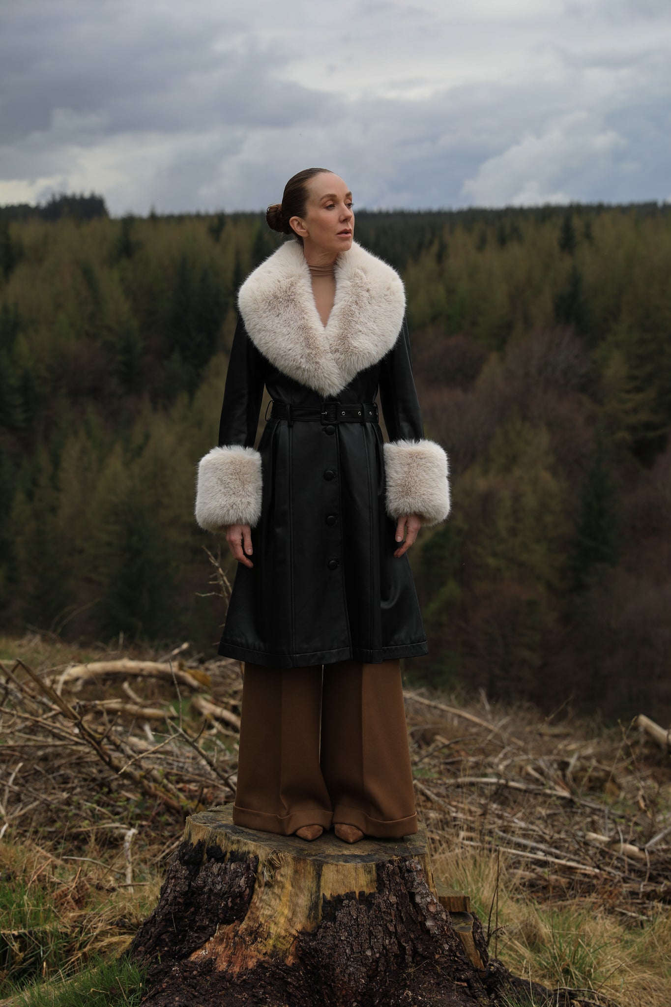 Josephine Jones' iconic black trench coat with oat faux fur collar and cuffs, crafted from genuine leather. A timeless blend of sophistication and warmth, perfect for elevating your winter style.