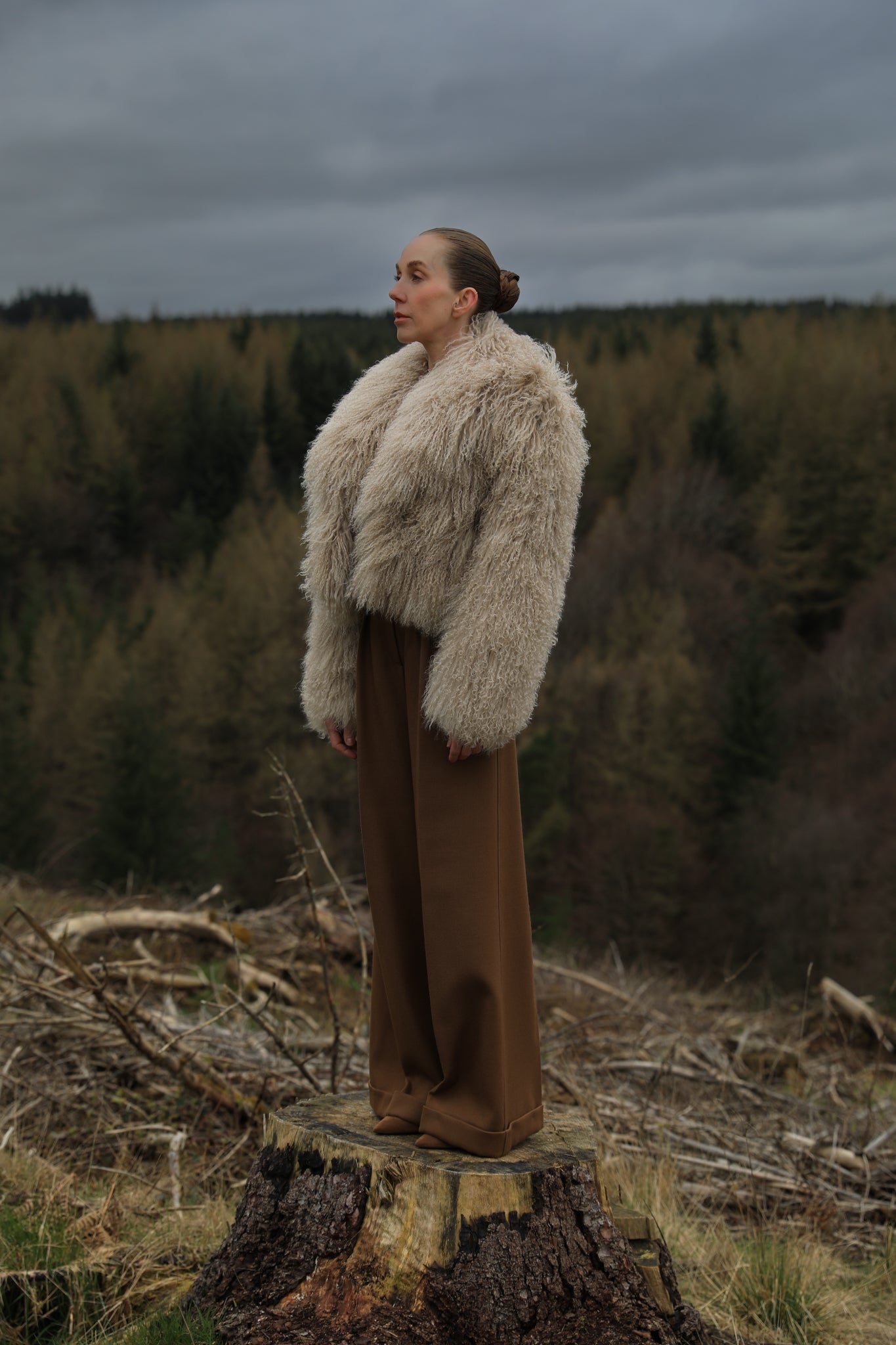 A  timeless beige Mongolian fur coat with a voluminous collar, a classic staple piece from Josephine Jones, exuding elegance and sophistication.