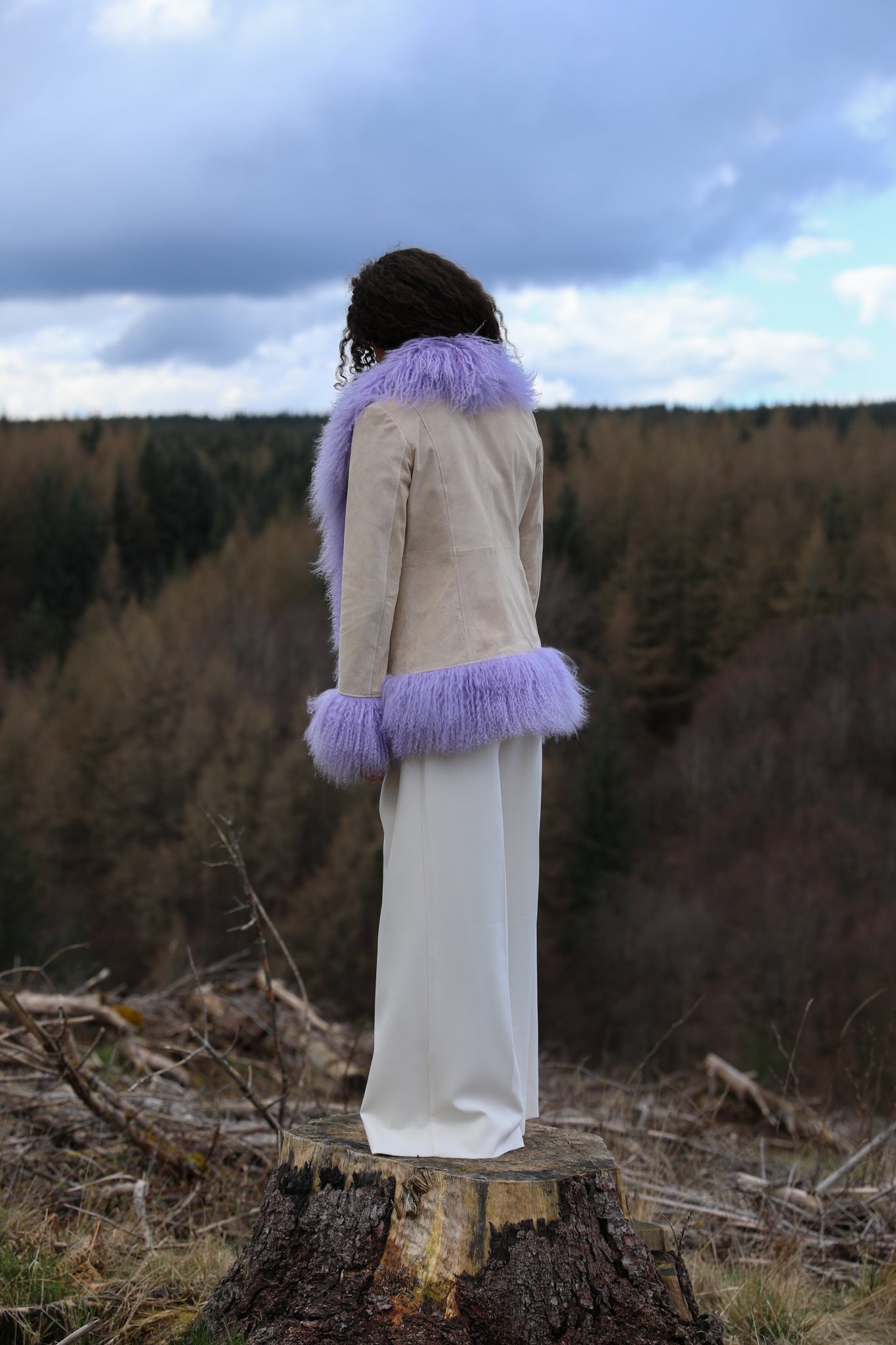 Ivory suede afghan penny lane jacket with lavender Mongolian fur trims, a timeless statement piece from Josephine Jones' collection. Luxurious, genuine suede construction adds texture and sophistication to any ensemble.