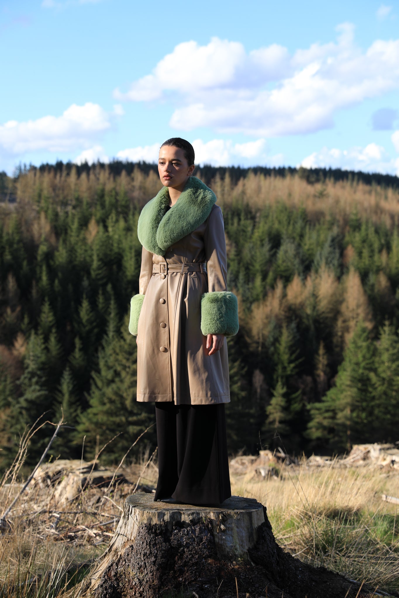 Beige trench coat with pistachio green faux fur collar and cuffs, crafted from genuine leather by Josephine Jones, offering timeless elegance and luxurious warmth for any occasion.