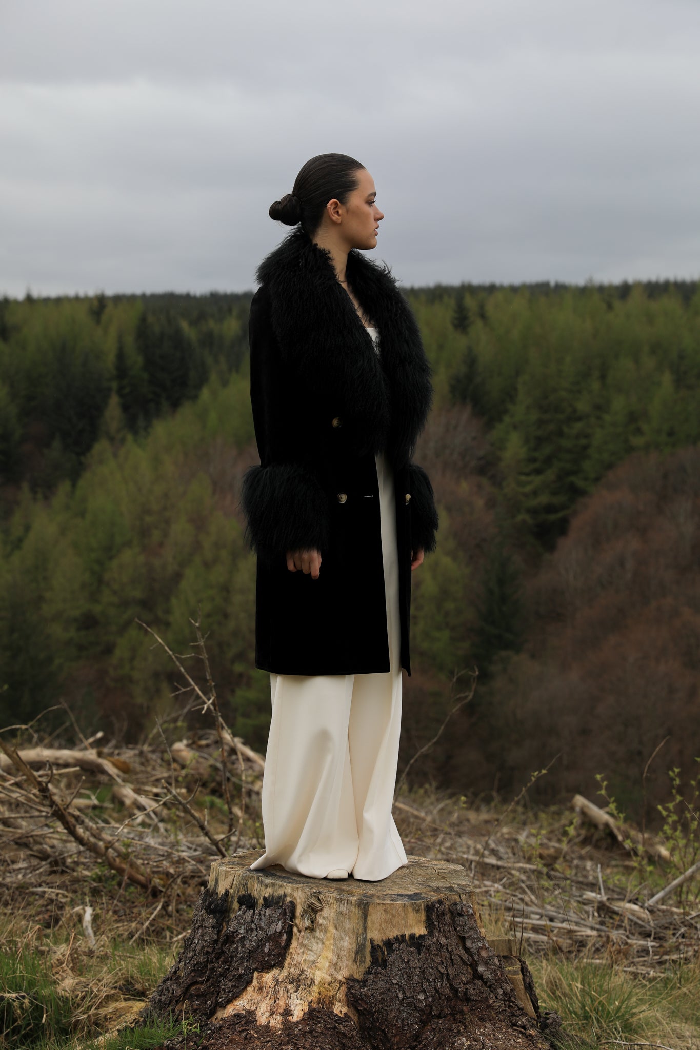 Black genuine suede trench wrap coat with Mongolian collar and cuffs, designed by Josephine Jones. Luxurious outerwear exuding elegance and warmth, perfect for any occasion