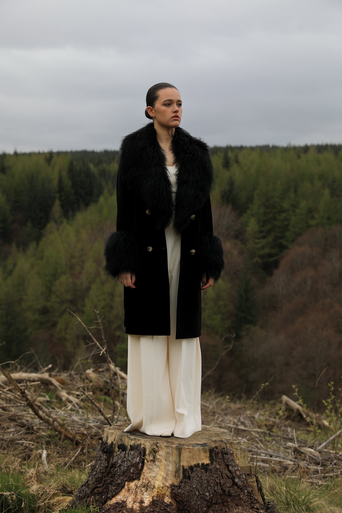 Black genuine suede trench wrap coat with Mongolian collar and cuffs, designed by Josephine Jones. Luxurious outerwear exuding elegance and warmth, perfect for any occasion