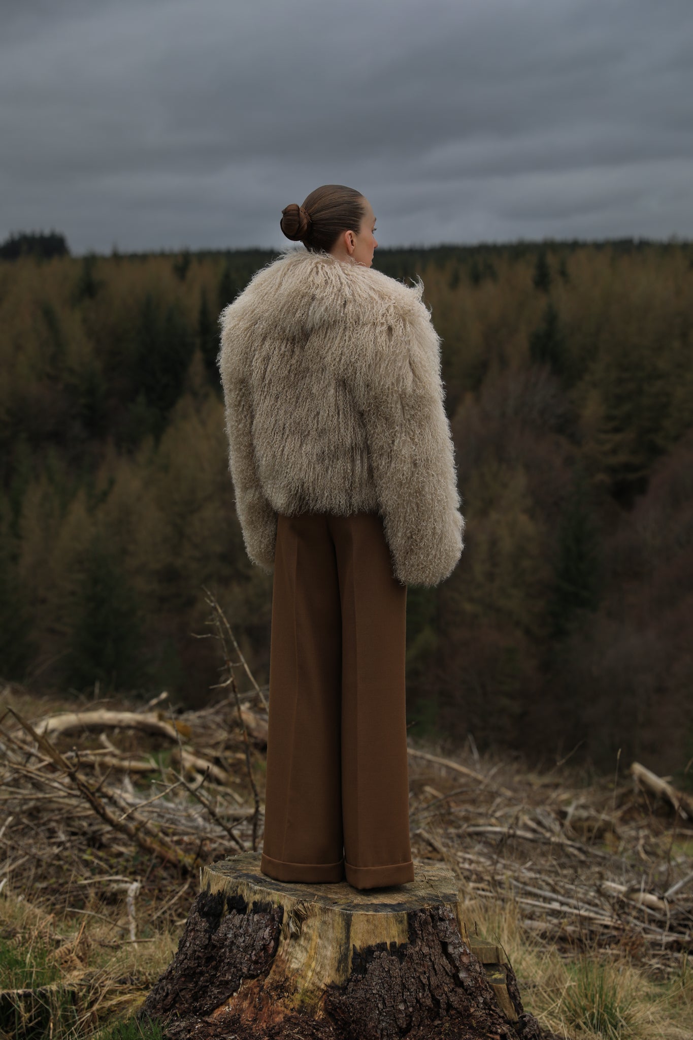 A  timeless beige Mongolian fur coat with a voluminous collar, a classic staple piece from Josephine Jones, exuding elegance and sophistication.