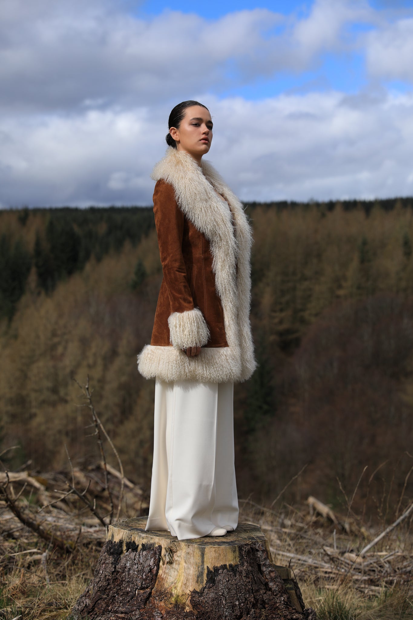 A stylish tan suede midi jacket from Josephine Jones, featuring classic Afghan Penny Lane style with elegant ivory Mongolian fur trims. Perfect for adding a touch of luxury to any outfit.