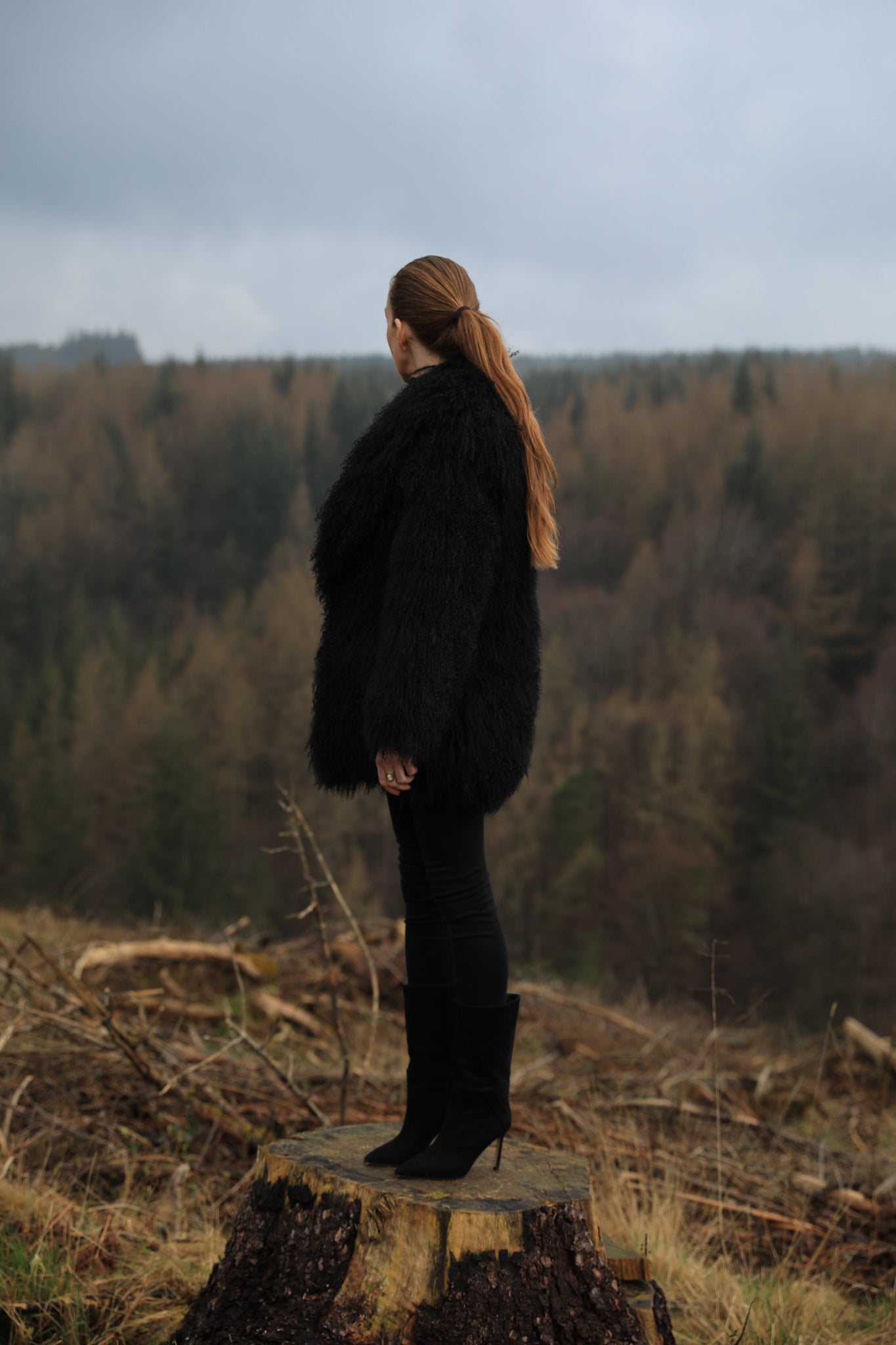 A luxurious mid-length black Mongolian fur coat from Josephine Jones, showcasing timeless elegance and sophistication in outerwear fashion.