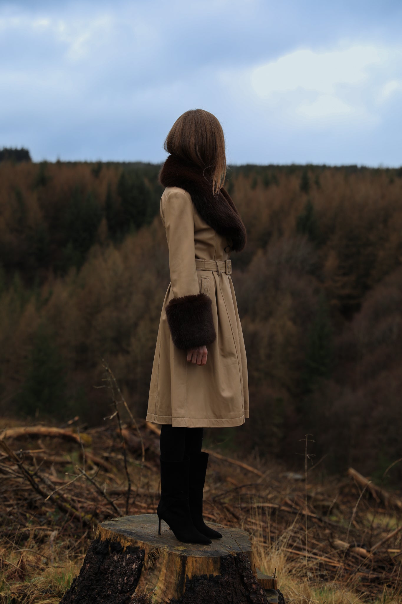 A sophisticated genuine leather beige trench coat from Josephine Jones, featuring a rich chocolate faux fur collar and cuffs. Elevate your style with this luxurious outerwear piece.