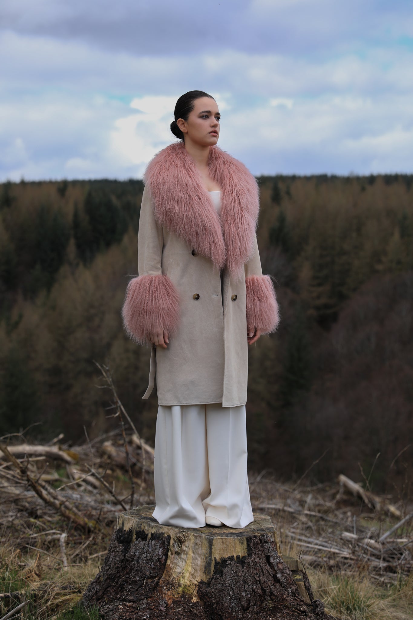 Ivory genuine suede trench wrap coat with blush Mongolian collar and cuffs, designed by Josephine Jones. Luxuriously crafted outerwear perfect for adding elegance to any ensemble.