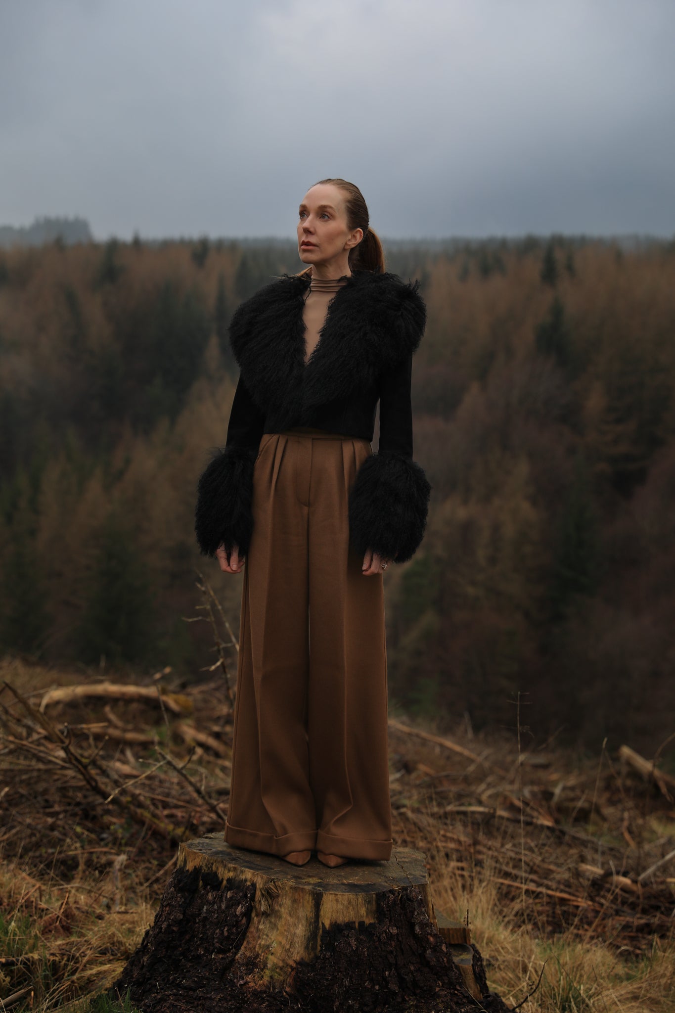  A sophisticated black genuine suede cropped jacket coat from Josephine Jones, featuring a luxurious Mongolian collar and cuffs. Perfect for adding a touch of elegance to any outfit.