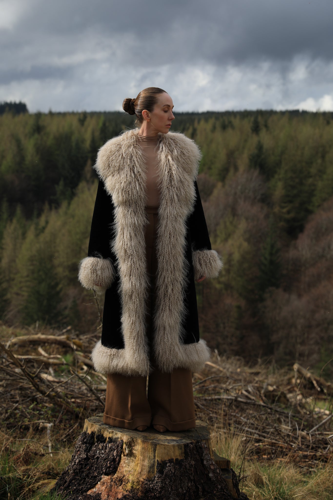 Josephine Jones bestselling long genuine shearling coat in beige and black, adorned with luxurious Mongolian fur trims. Stay chic and cozy in this elegant outerwear essential.