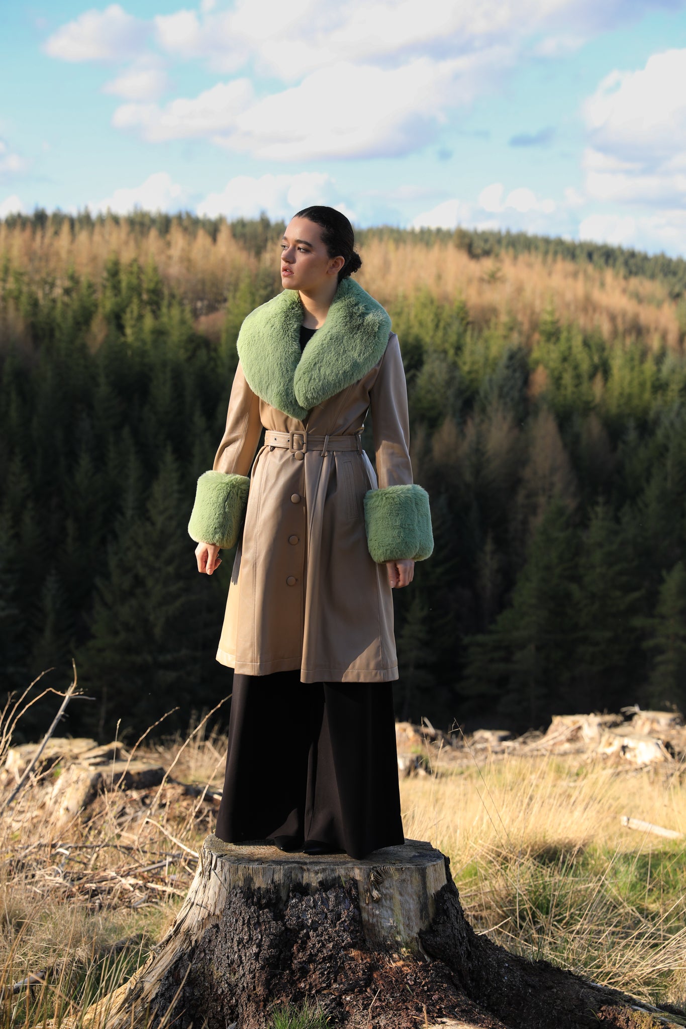 Beige trench coat with pistachio green faux fur collar and cuffs, crafted from genuine leather by Josephine Jones, offering timeless elegance and luxurious warmth for any occasion.