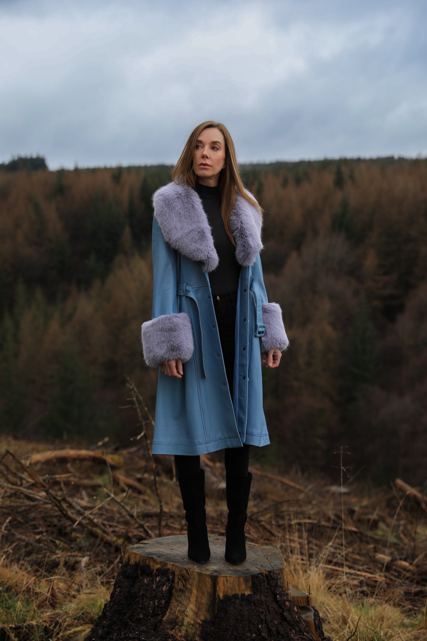 Genuine leather blue trench coat with lavender faux fur collar and cuffs, a stylish creation from Josephine Jones. Perfect for adding a touch of elegance and warmth to any ensemble.