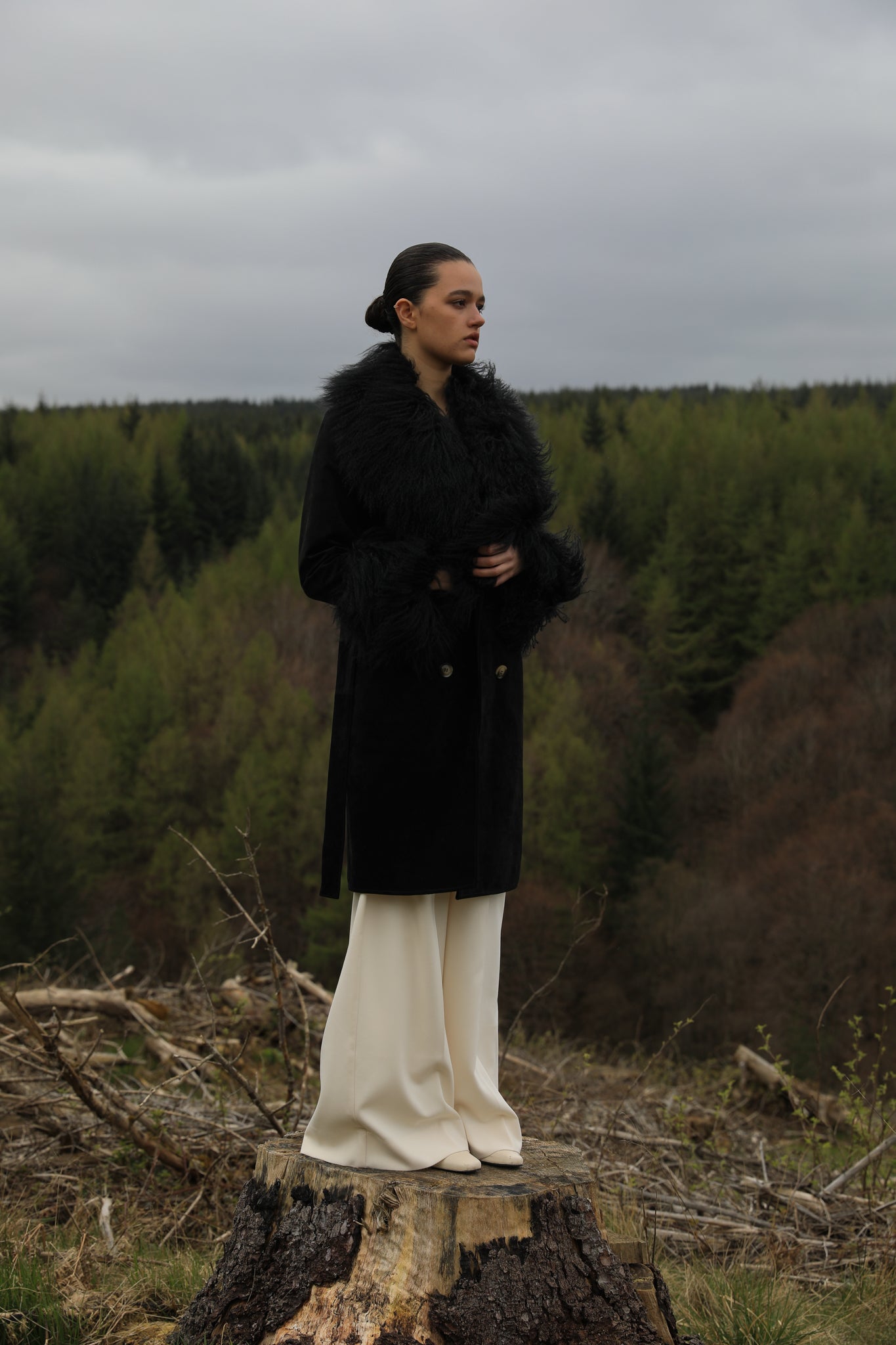 Black genuine suede trench wrap coat with Mongolian collar and cuffs, designed by Josephine Jones. Luxurious outerwear exuding elegance and warmth, perfect for any occasion