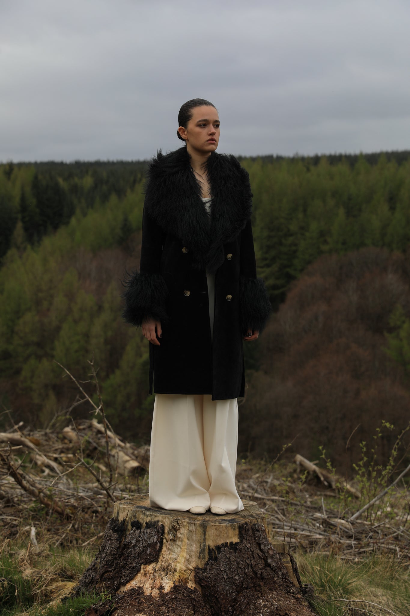 Black genuine suede trench wrap coat with Mongolian collar and cuffs, designed by Josephine Jones. Luxurious outerwear exuding elegance and warmth, perfect for any occasion