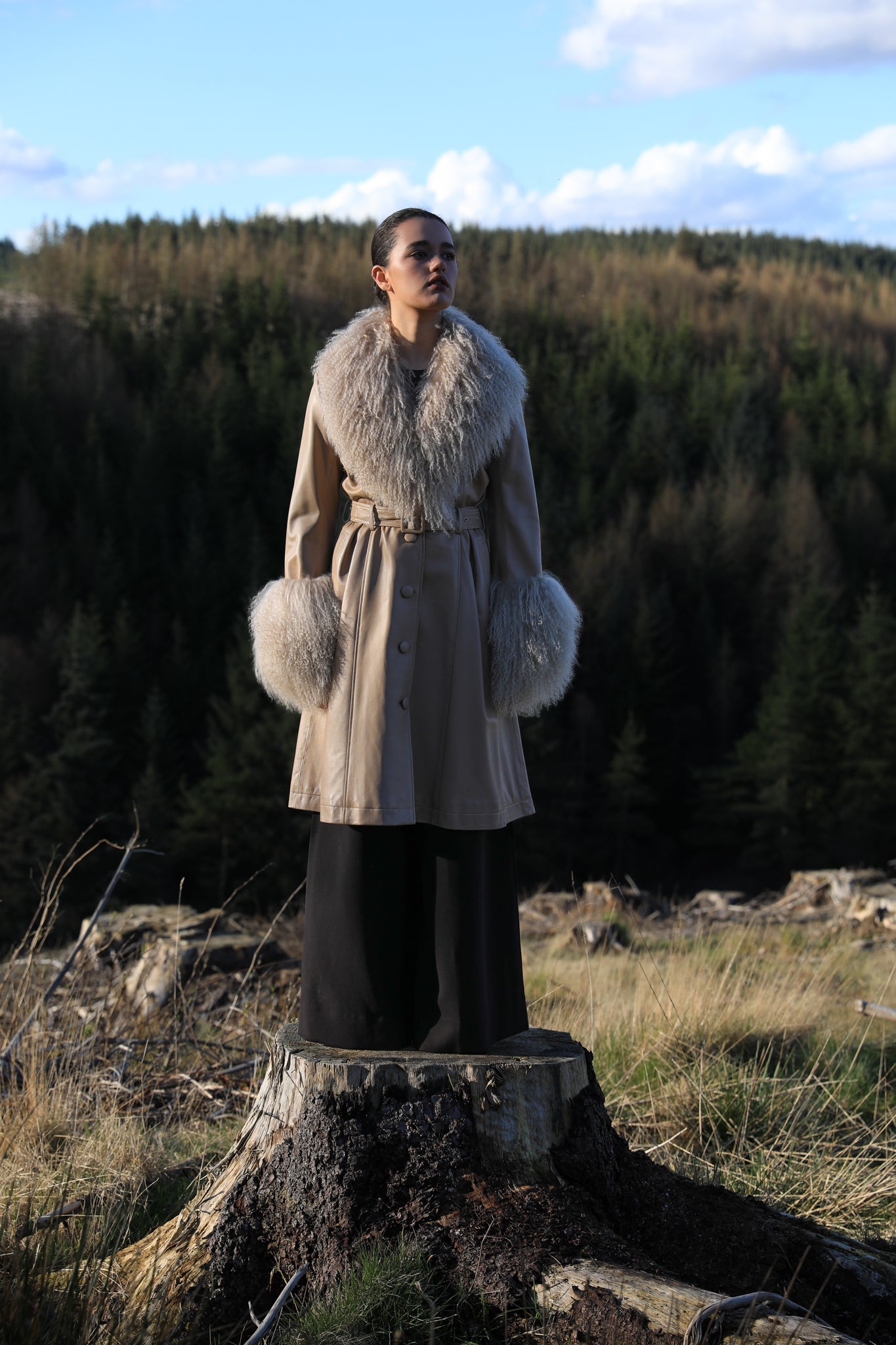 Josephine Jones beige trench coat with Mongolian collar and cuffs, crafted from genuine leather. Elevate your style with this luxurious outerwear piece.'