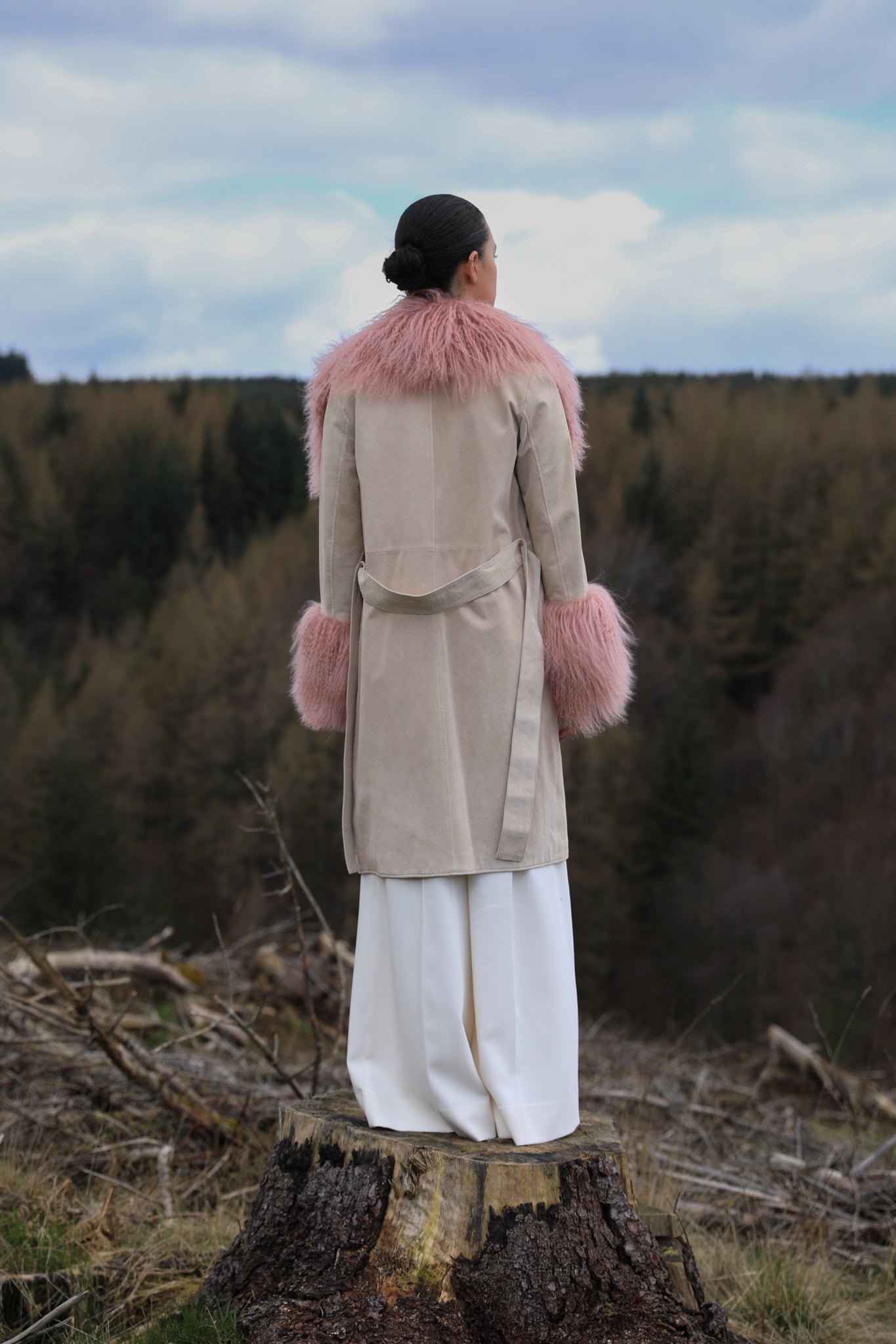 Ivory genuine suede trench wrap coat with blush Mongolian collar and cuffs, designed by Josephine Jones. Luxuriously crafted outerwear perfect for adding elegance to any ensemble.