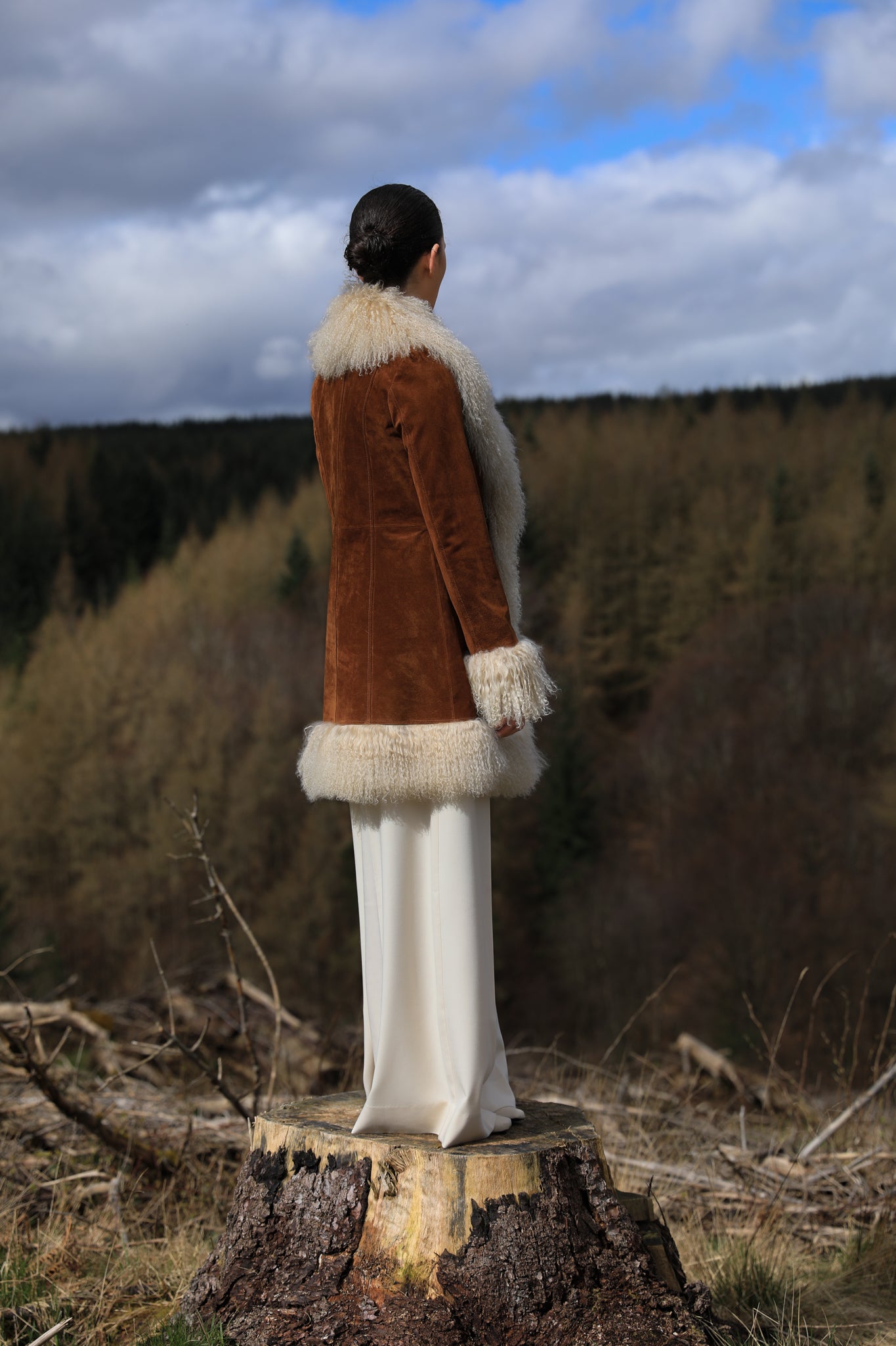 A stylish tan suede midi jacket from Josephine Jones, featuring classic Afghan Penny Lane style with elegant ivory Mongolian fur trims. Perfect for adding a touch of luxury to any outfit.