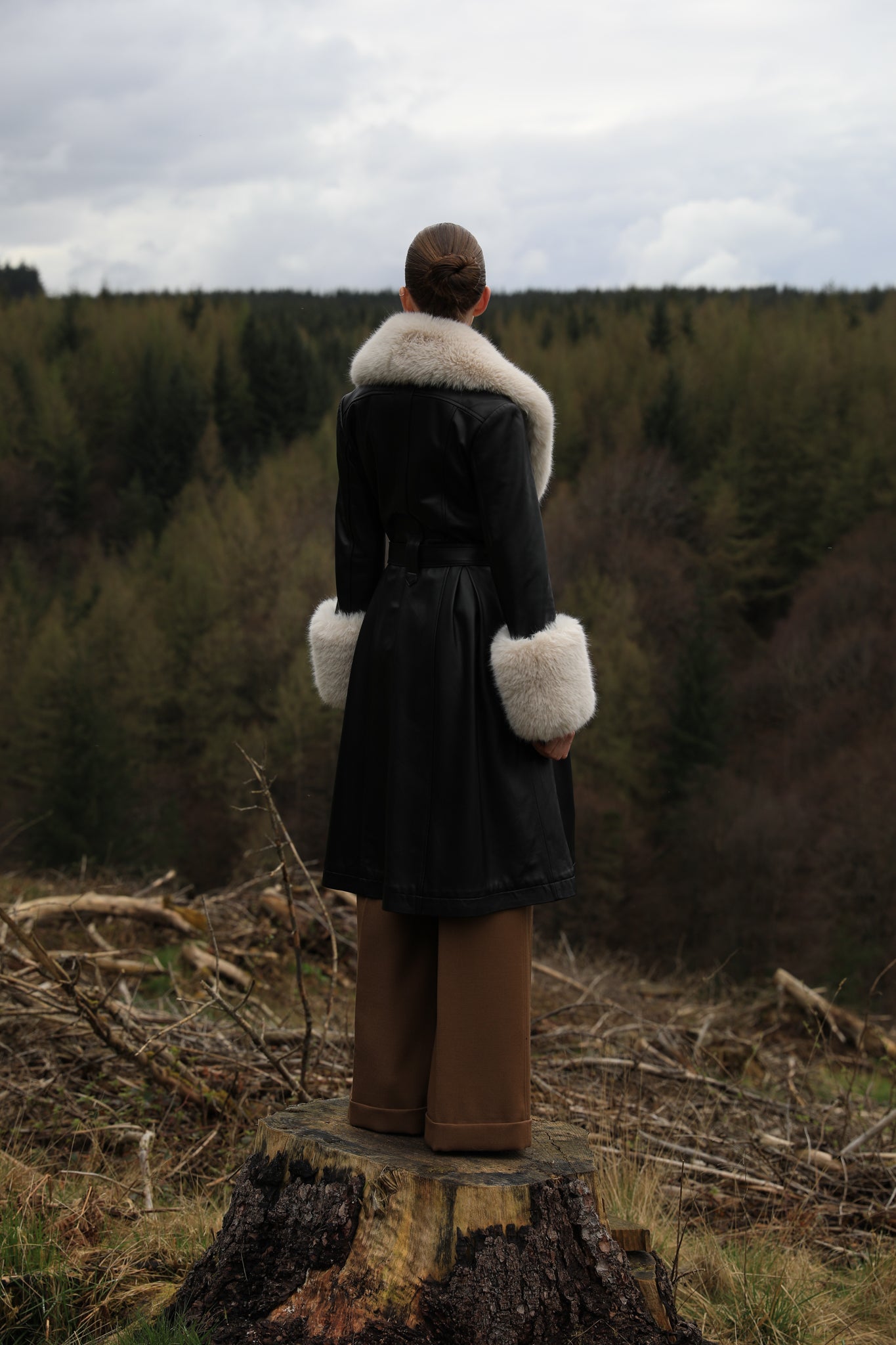 Josephine Jones' iconic black trench coat with oat faux fur collar and cuffs, crafted from genuine leather. A timeless blend of sophistication and warmth, perfect for elevating your winter style.