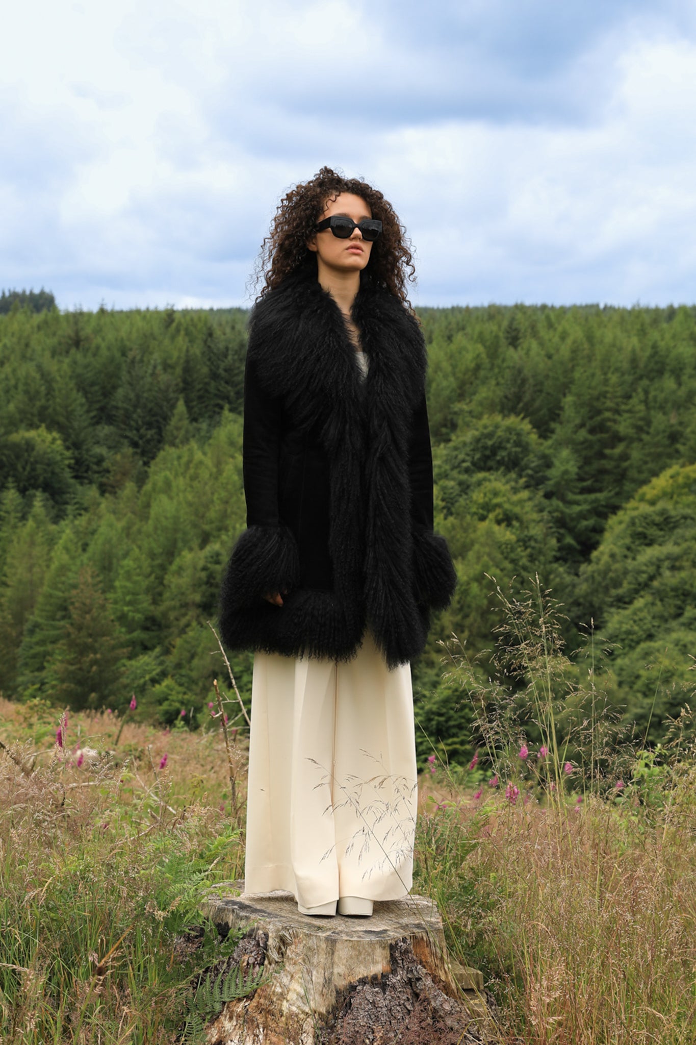 A stylish black suede midi jacket with black Mongolian fur trims, reminiscent of the iconic Penny Lane style. Crafted by Josephine Jones, this genuine suede coat exudes timeless elegance and sophistication, perfect for any fashion-forward wardrobe.