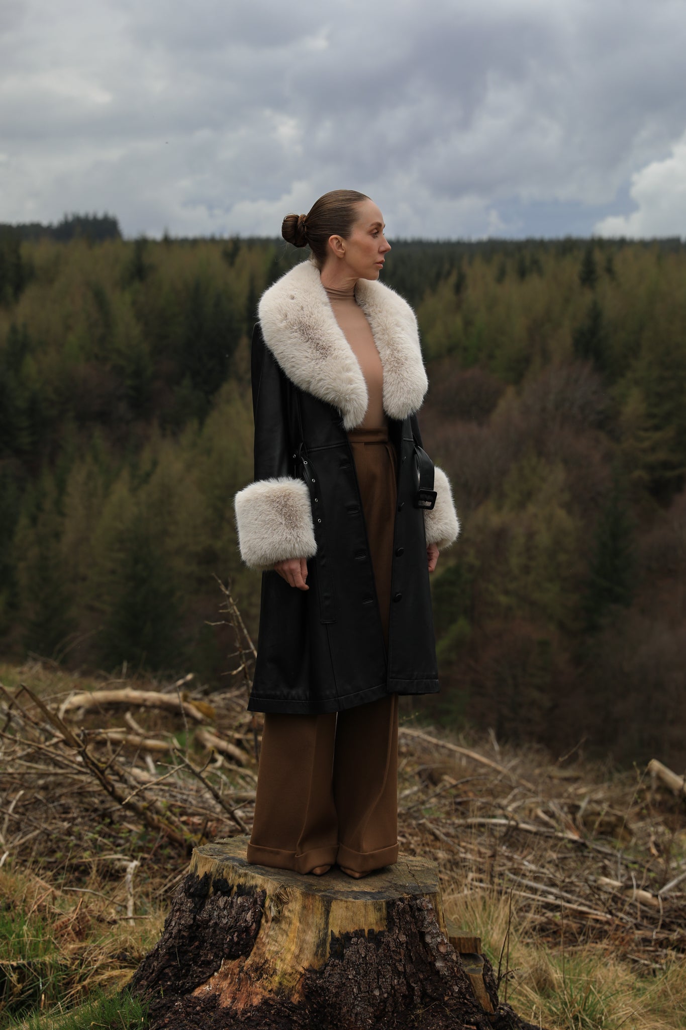 Josephine Jones' iconic black trench coat with oat faux fur collar and cuffs, crafted from genuine leather. A timeless blend of sophistication and warmth, perfect for elevating your winter style.