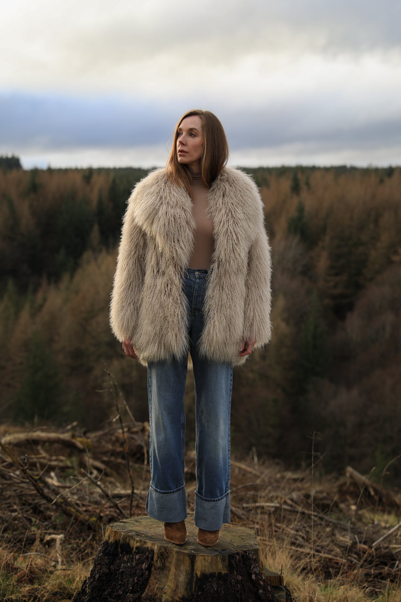 Beige Mongolian fur mid-length coat from Josephine Jones. This luxurious coat features soft fur with a mid-length design, perfect for adding elegance and warmth to any outfit.