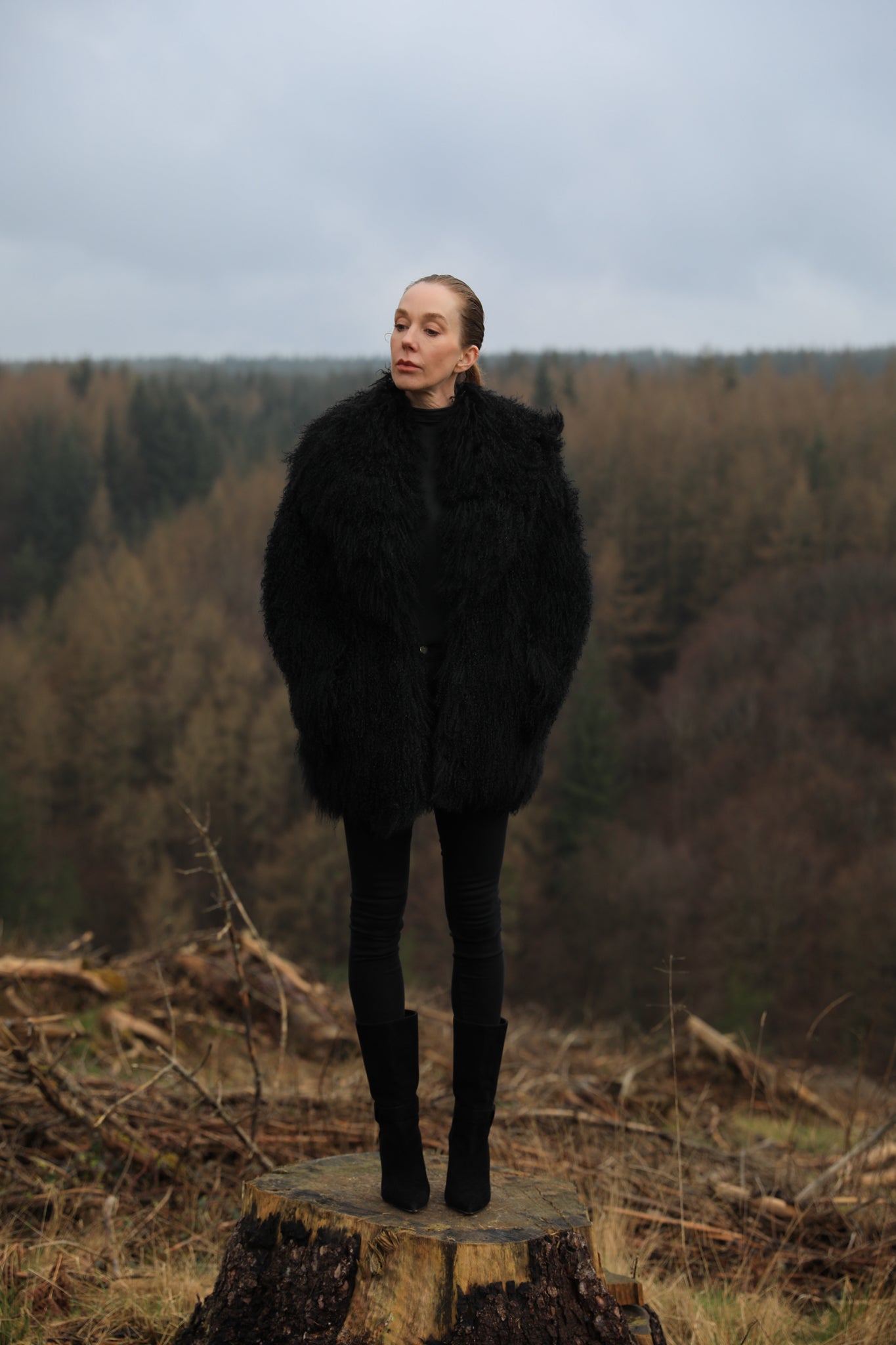 A luxurious mid-length black Mongolian fur coat from Josephine Jones, showcasing timeless elegance and sophistication in outerwear fashion.