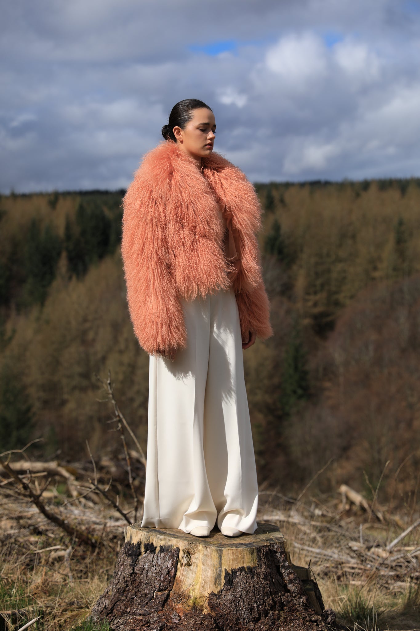 A timeless statement piece - Josephine Jones' voluminous collar Mongolian fur coat in peach hue, exuding elegance and luxury.