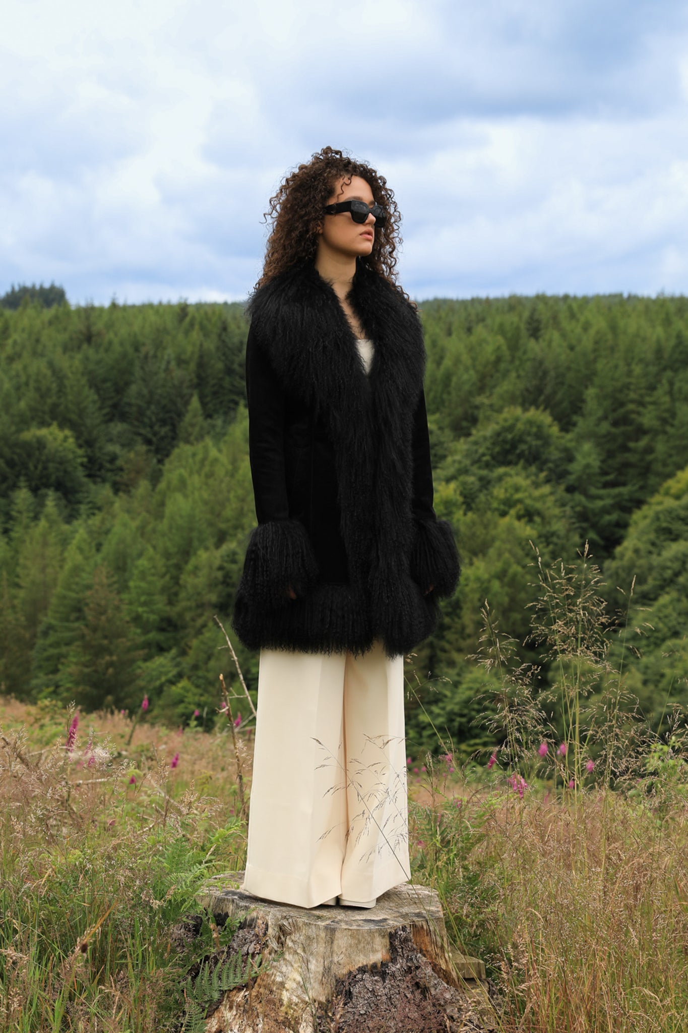 A stylish black suede midi jacket with black Mongolian fur trims, reminiscent of the iconic Penny Lane style. Crafted by Josephine Jones, this genuine suede coat exudes timeless elegance and sophistication, perfect for any fashion-forward wardrobe.