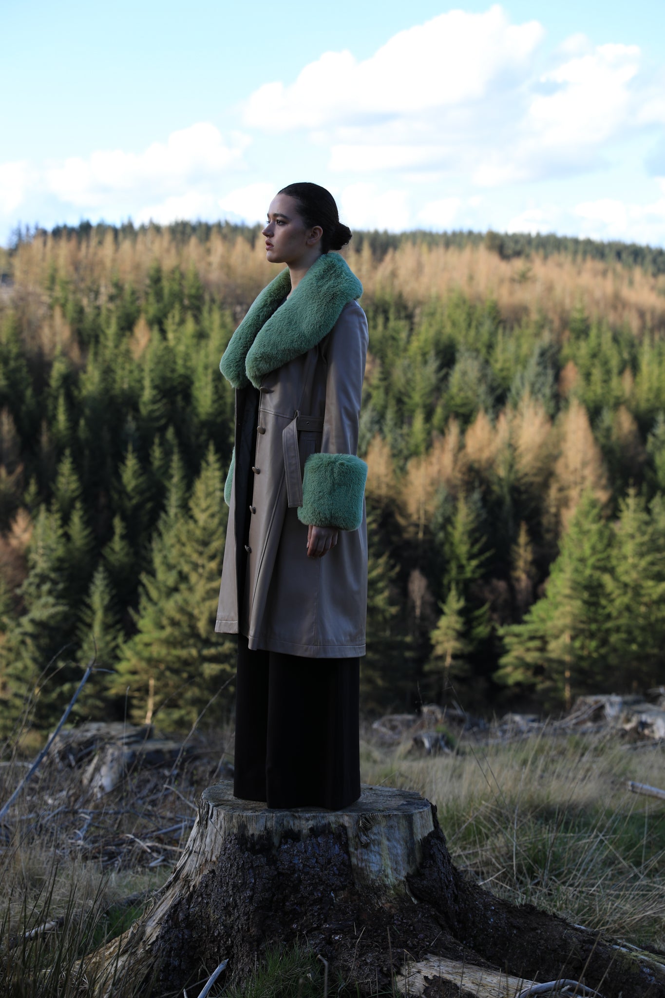 Beige trench coat with pistachio green faux fur collar and cuffs, crafted from genuine leather by Josephine Jones, offering timeless elegance and luxurious warmth for any occasion.