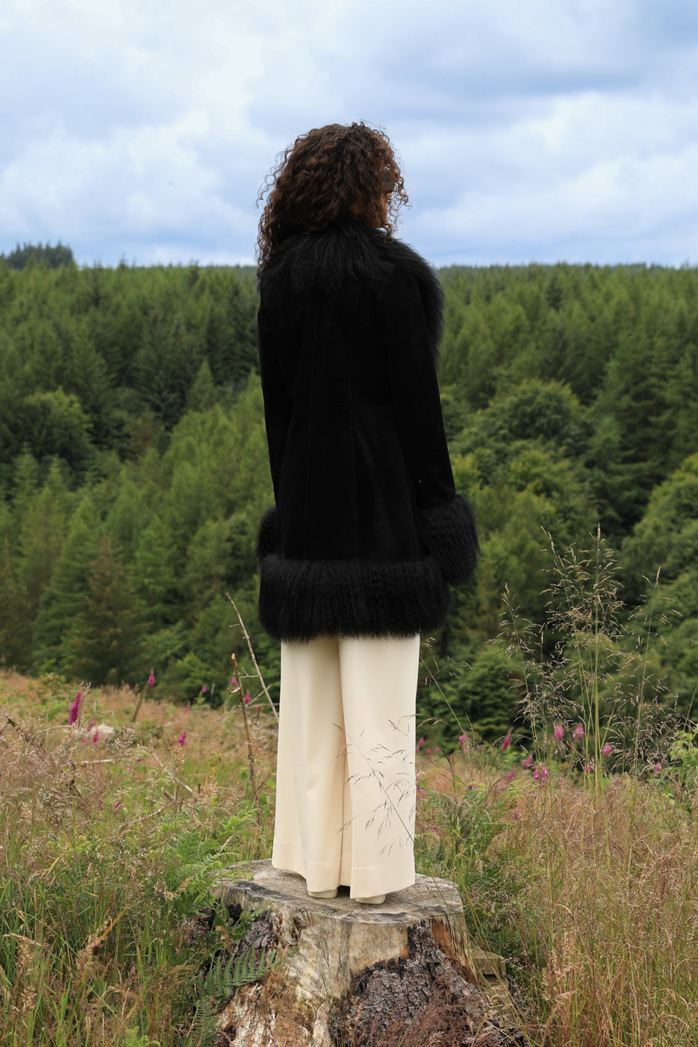 A stylish black suede midi jacket with black Mongolian fur trims, reminiscent of the iconic Penny Lane style. Crafted by Josephine Jones, this genuine suede coat exudes timeless elegance and sophistication, perfect for any fashion-forward wardrobe.