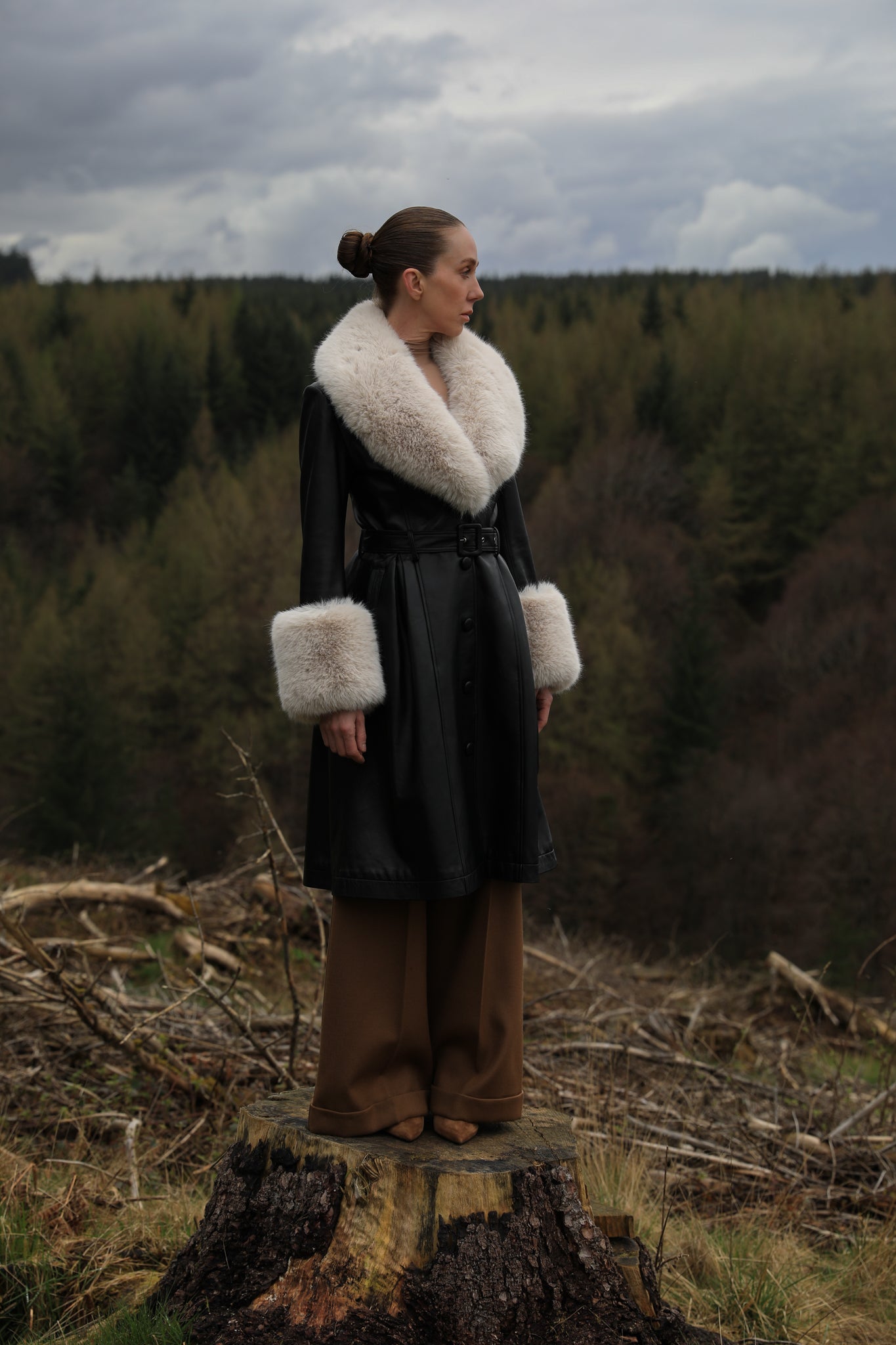 Josephine Jones' iconic black trench coat with oat faux fur collar and cuffs, crafted from genuine leather. A timeless blend of sophistication and warmth, perfect for elevating your winter style.