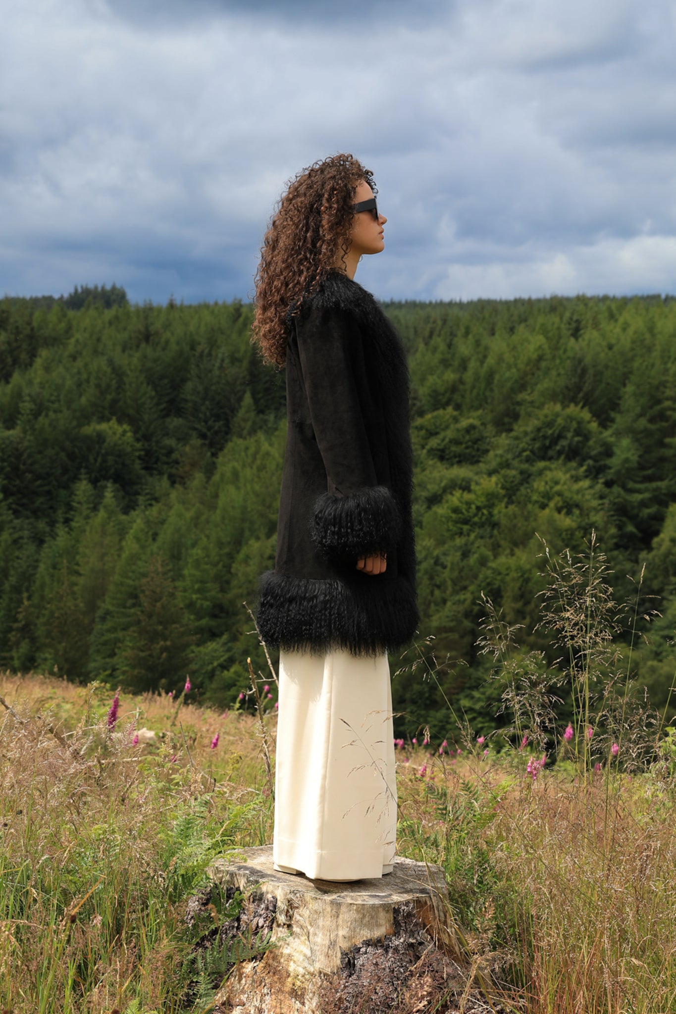 Black genuine suede Afghan Penny Lane coat with mid-length silhouette and crew neck, designed by Josephine Jones. Luxurious outerwear perfect for stylish winter ensembles.