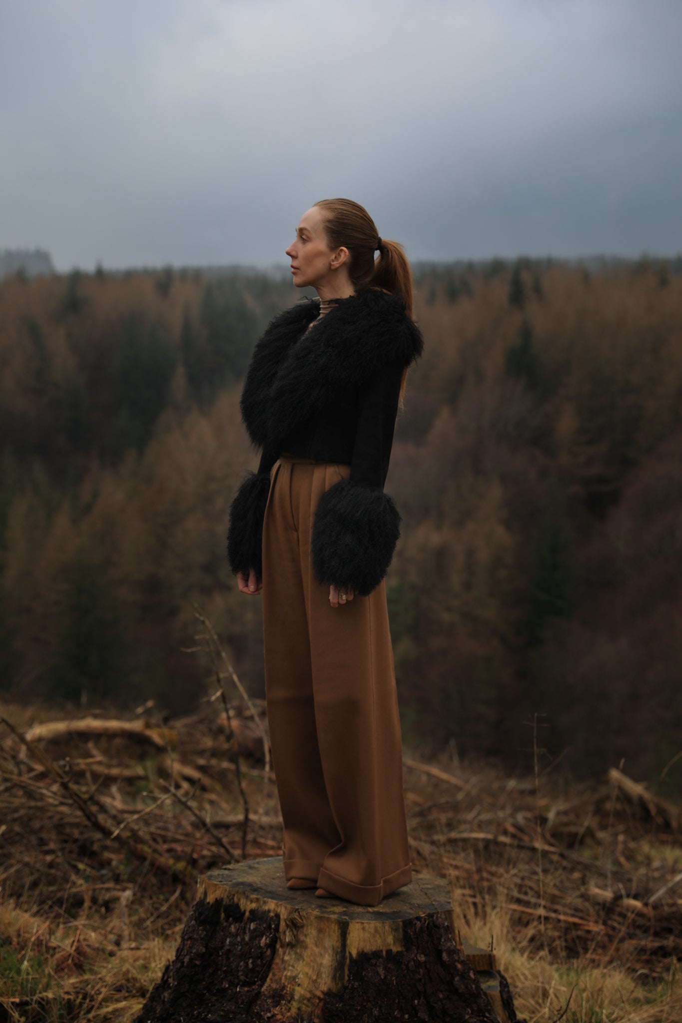  A sophisticated black genuine suede cropped jacket coat from Josephine Jones, featuring a luxurious Mongolian collar and cuffs. Perfect for adding a touch of elegance to any outfit.