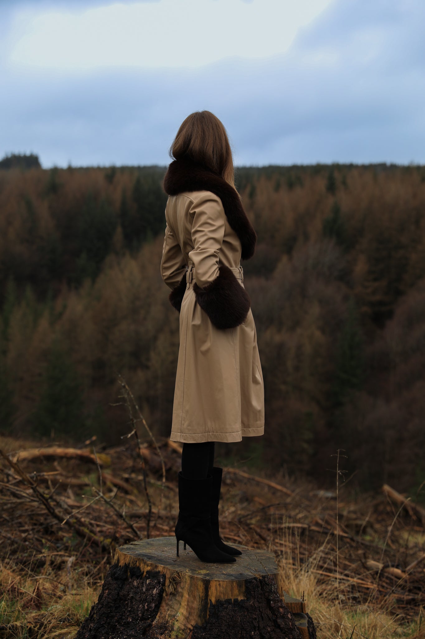 A sophisticated genuine leather beige trench coat from Josephine Jones, featuring a rich chocolate faux fur collar and cuffs. Elevate your style with this luxurious outerwear piece.