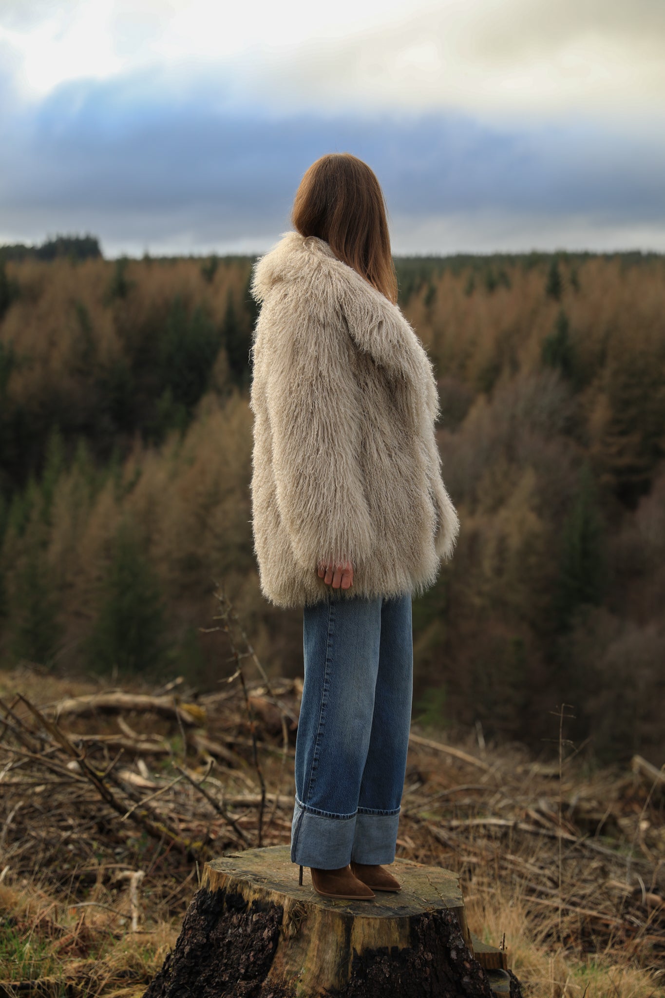 Beige Mongolian fur mid-length coat from Josephine Jones. This luxurious coat features soft fur with a mid-length design, perfect for adding elegance and warmth to any outfit.