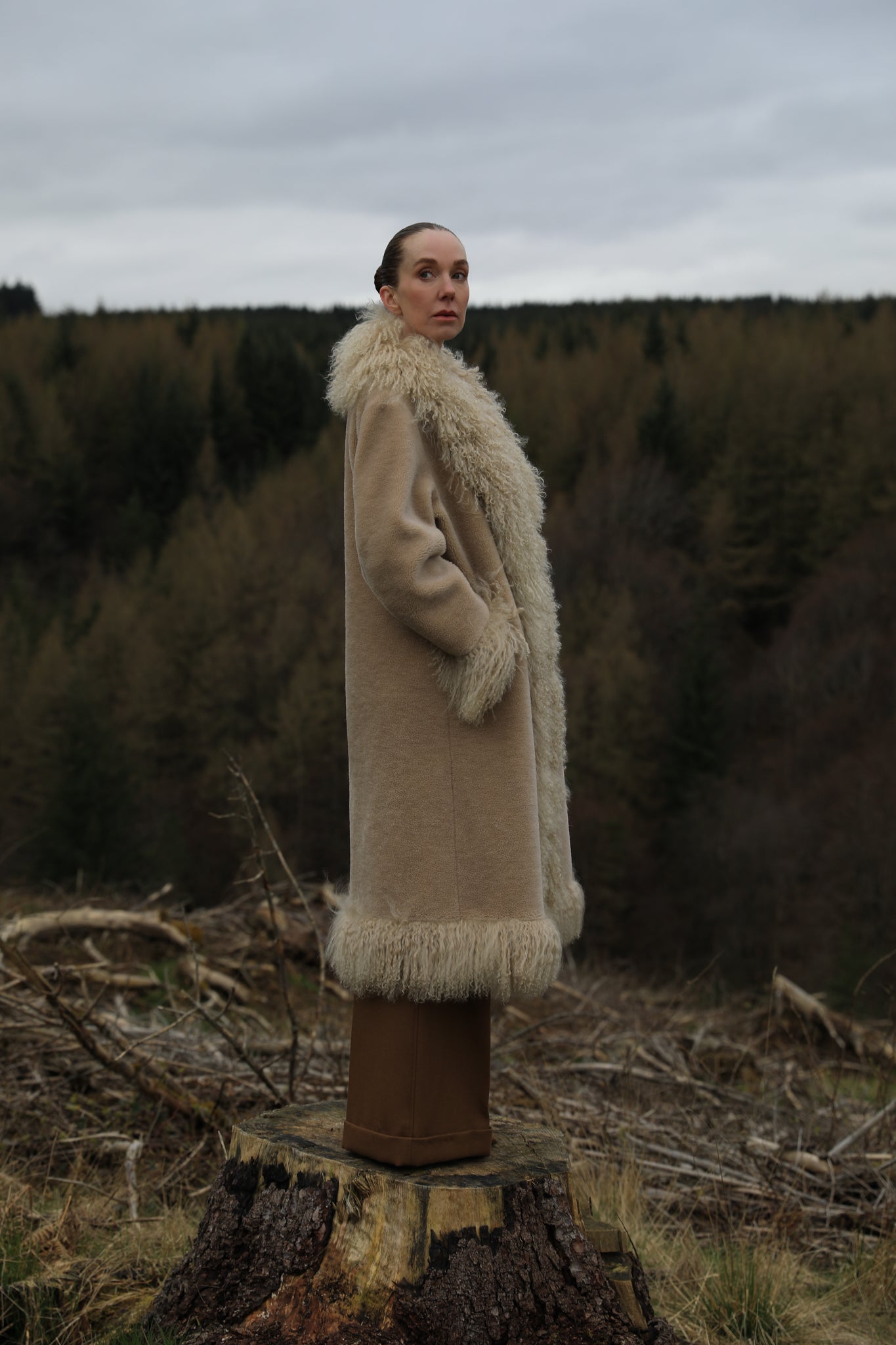  A bestselling long genuine shearling coat in beige/teddy color, designed by Josephine Jones. This luxurious coat features exquisite Mongolian fur trims, offering warmth and style for any occasion.