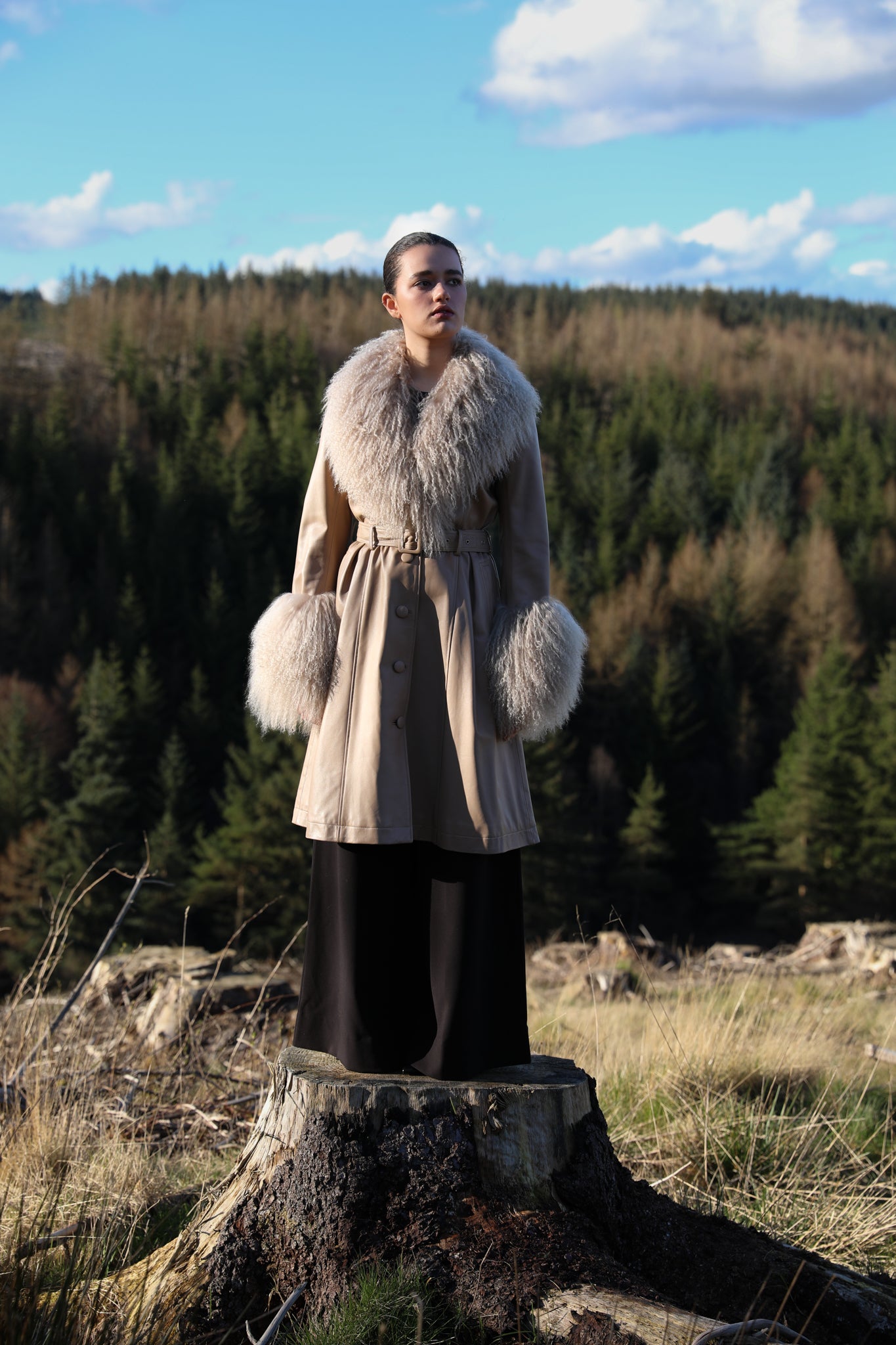 Josephine Jones beige trench coat with Mongolian collar and cuffs, crafted from genuine leather. Elevate your style with this luxurious outerwear piece.'