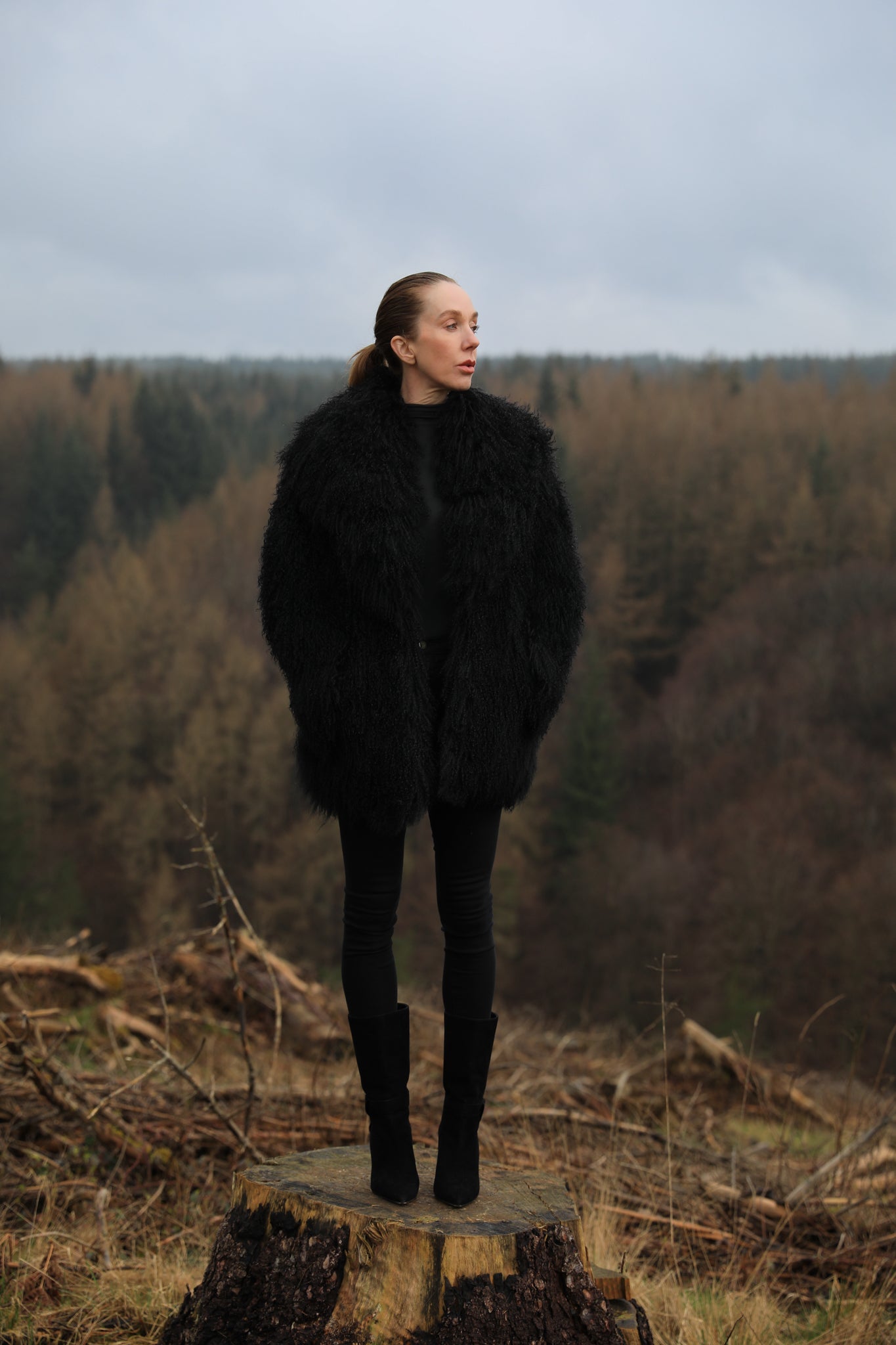 A luxurious mid-length black Mongolian fur coat from Josephine Jones, showcasing timeless elegance and sophistication in outerwear fashion.