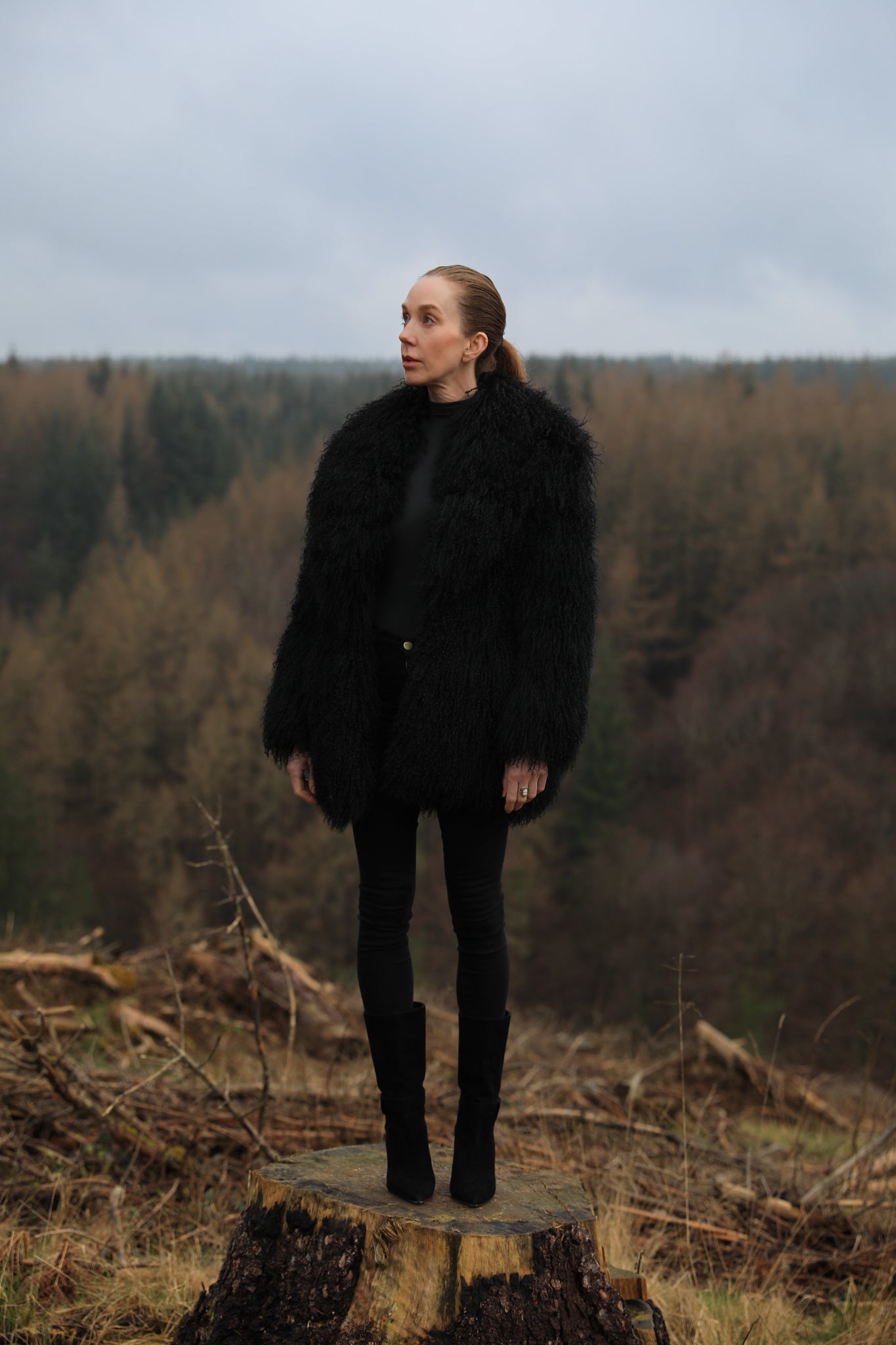 A luxurious mid-length black Mongolian fur coat from Josephine Jones, showcasing timeless elegance and sophistication in outerwear fashion.