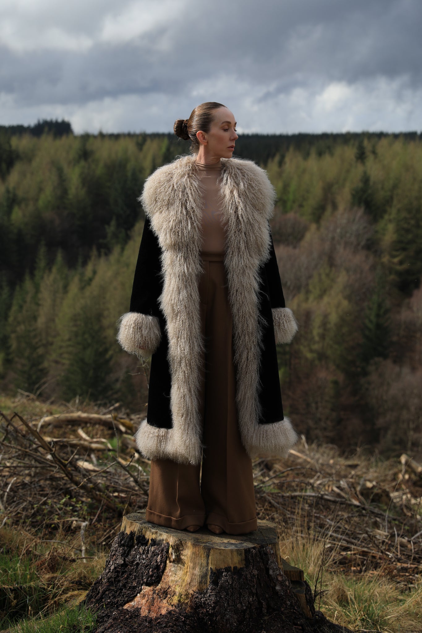 Josephine Jones bestselling long genuine shearling coat in beige and black, adorned with luxurious Mongolian fur trims. Stay chic and cozy in this elegant outerwear essential.