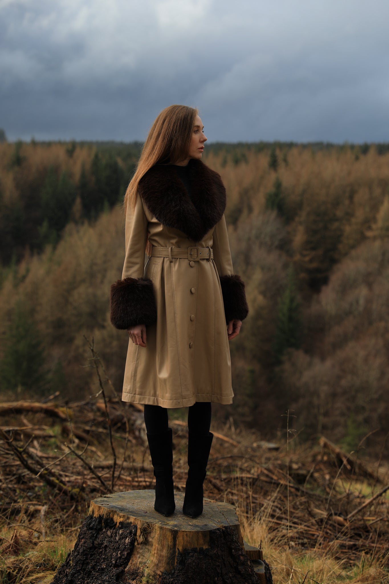 A sophisticated genuine leather beige trench coat from Josephine Jones, featuring a rich chocolate faux fur collar and cuffs. Elevate your style with this luxurious outerwear piece.