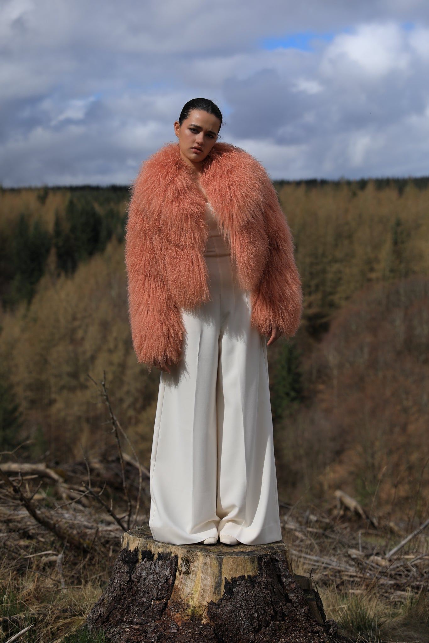 A timeless statement piece - Josephine Jones' voluminous collar Mongolian fur coat in peach hue, exuding elegance and luxury.