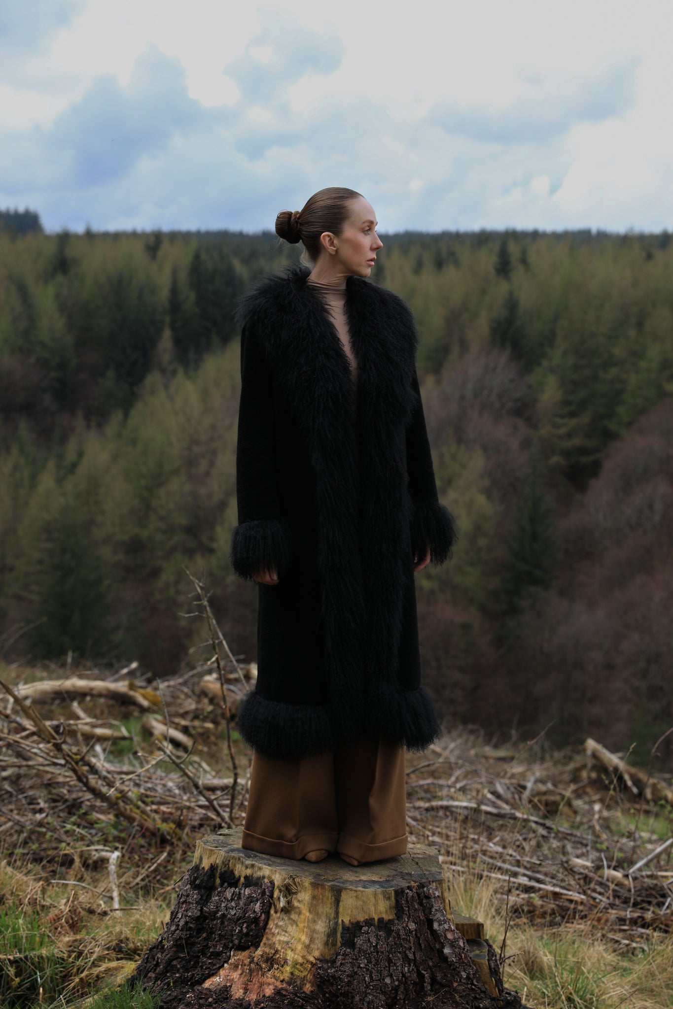 Black long genuine shearling coat with Mongolian fur trims from Josephine Jones - A bestselling luxury outerwear piece exuding elegance and warmth.