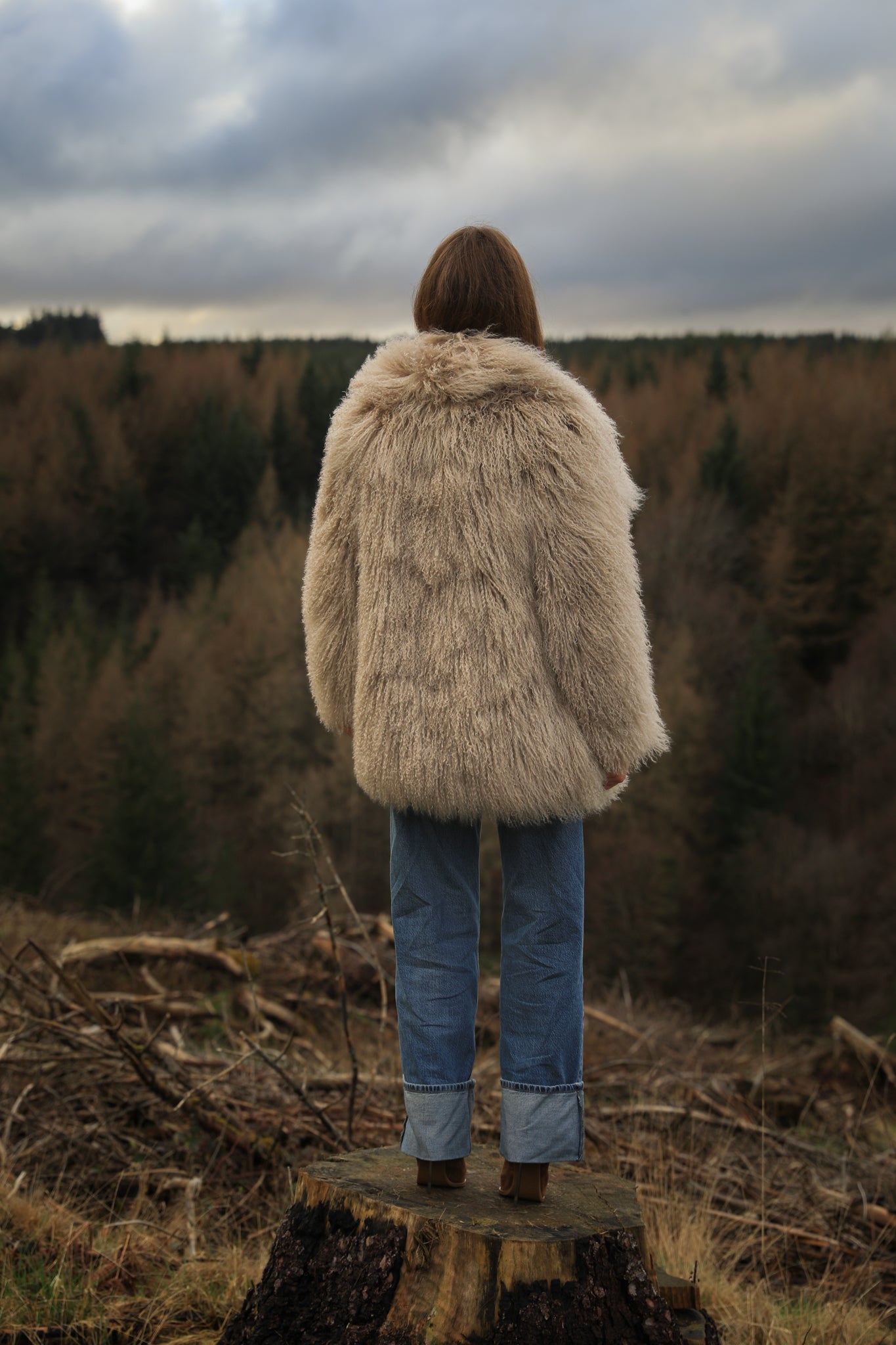 Beige Mongolian fur mid-length coat from Josephine Jones. This luxurious coat features soft fur with a mid-length design, perfect for adding elegance and warmth to any outfit.