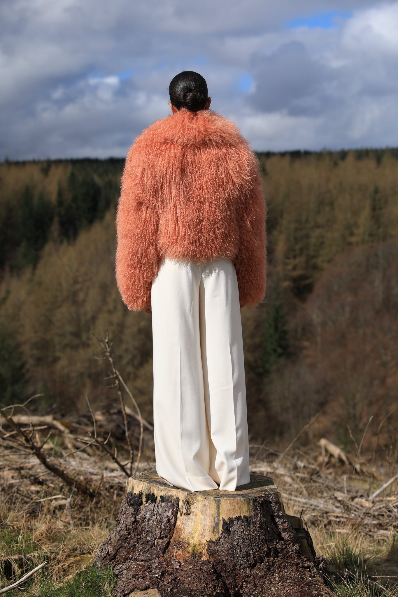 A timeless statement piece - Josephine Jones' voluminous collar Mongolian fur coat in peach hue, exuding elegance and luxury.