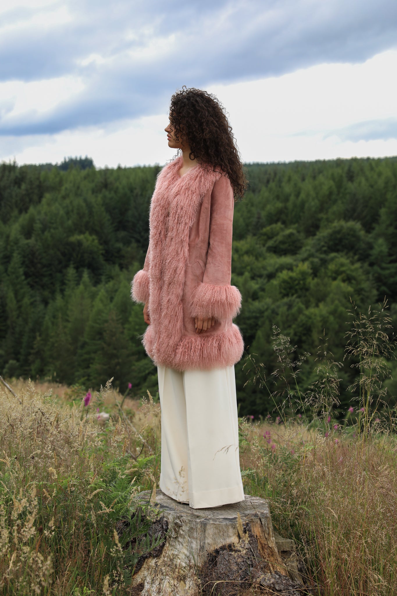 Blush genuine suede Afghan Penny Lane coat with mid-length design and crew neck, crafted by Josephine Jones.' This alt text provides a concise description of the coat, including its color, material, style, and designer, ensuring accessibility for visually impaired users.